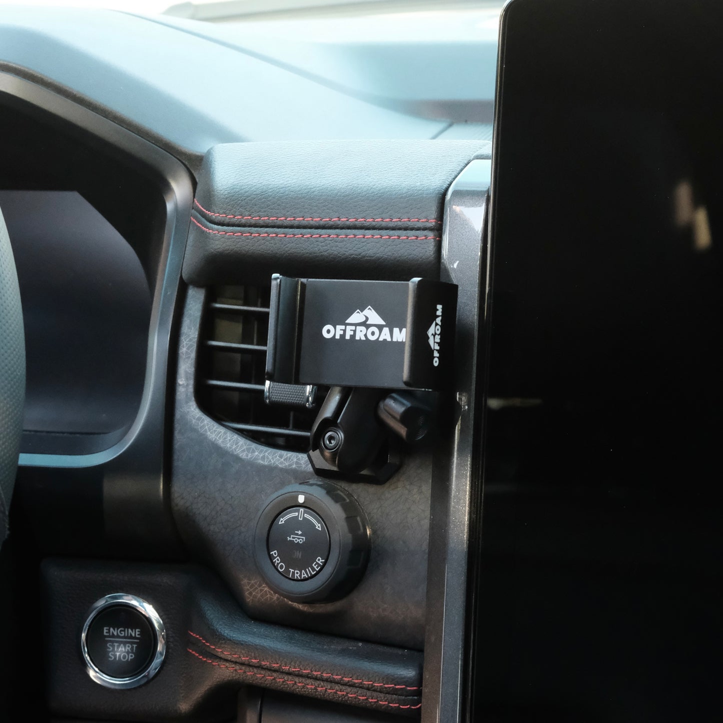 Image of Offroam Phone Mount installed securely in Ford F-150 Lightning 2022-2025 (Lariat & Platinum) | Expedition 2022-2024. This premium phone mount installs easily without drilling or glue. Spring loaded Universal holder for use with any phone. Perfect placement without blocking screens, driver view, or air flow. Fully adjustable positioning.