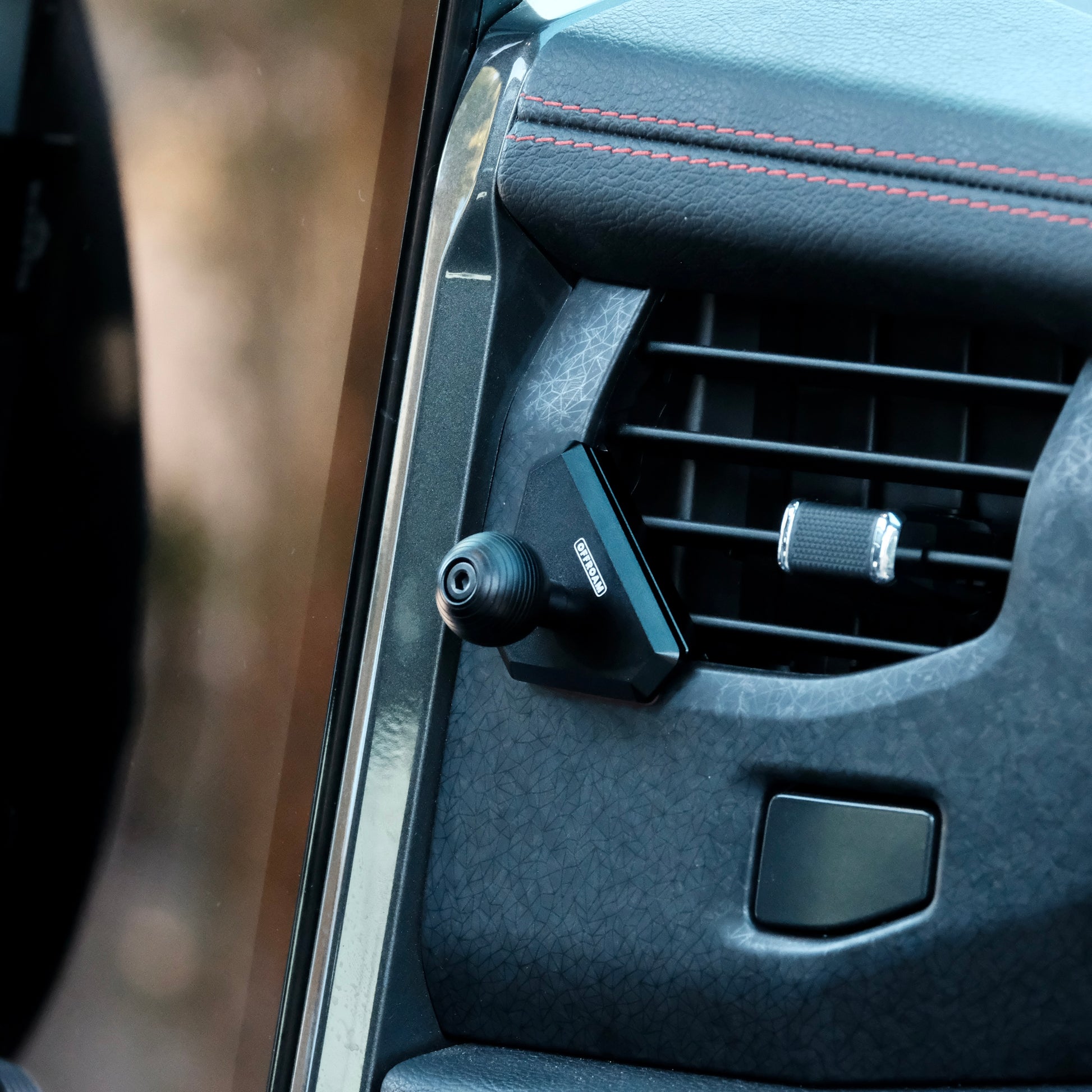 Image of Offroam Mounting Base installed securely in Ford F-150 Lightning 2022-2025 (Lariat & Platinum) | Expedition 2022-2024. This premium all metal phone mounting base installs easily without drilling or glue. Perfect placement without blocking screens, driver view, or air flow.