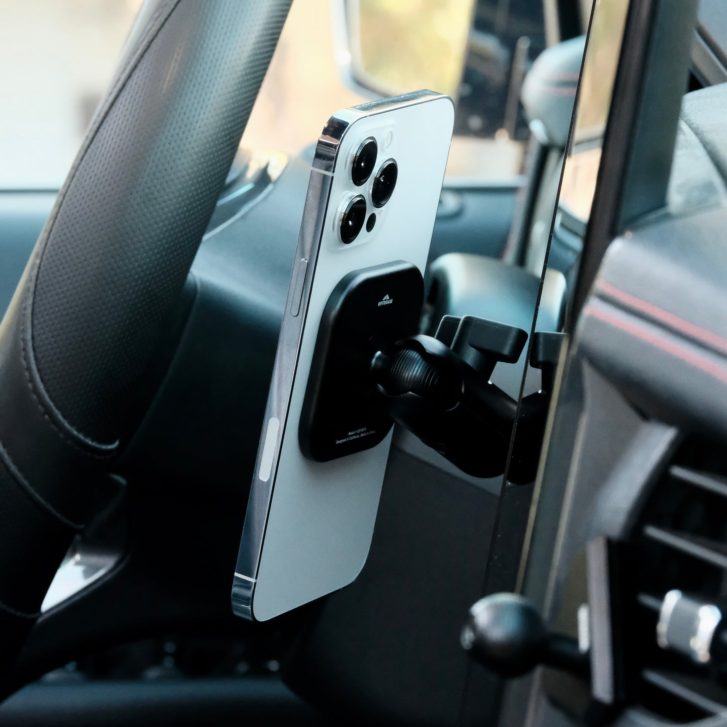 Image of Offroam MagSafe-compatible Phone Mount installed securely in Ford F-150 Lightning 2022-2025 (Lariat & Platinum) | Ford Expedition 2022-2024. This premium phone mount installs easily without drilling or glue. High force magnets hold phone on any trail, road, or track. Perfect placement without blocking screens, driver view, or air flow. Fully adjustable positioning.