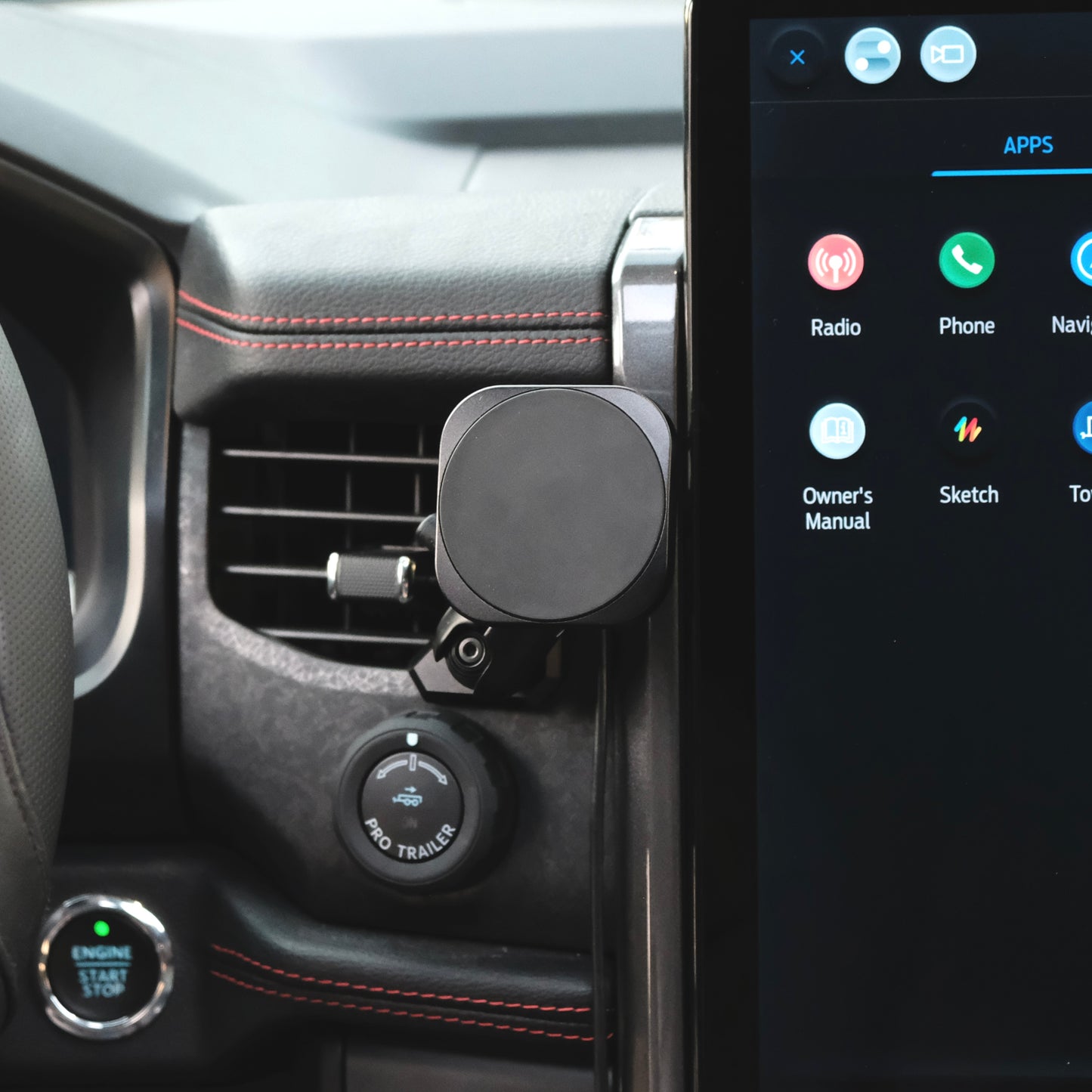 Image of Offroam MagSafe-compatible Phone Mount installed securely in Ford F-150 Lightning 2022-2025 (Lariat & Platinum) | Ford Expedition 2022-2024. This premium phone mount installs easily without drilling or glue. High force magnets hold phone on any trail, road, or track. Perfect placement without blocking screens, driver view, or air flow. Fully adjustable positioning.