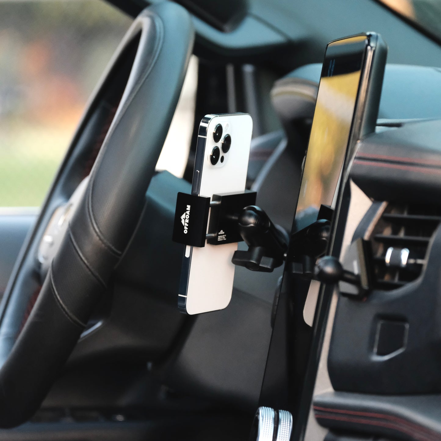Image of Offroam Phone Mount installed securely in Ford F-150 Lightning 2022-2025 (Lariat & Platinum) | Expedition 2022-2024. This premium phone mount installs easily without drilling or glue. Spring loaded Universal holder for use with any phone. Perfect placement without blocking screens, driver view, or air flow. Fully adjustable positioning.