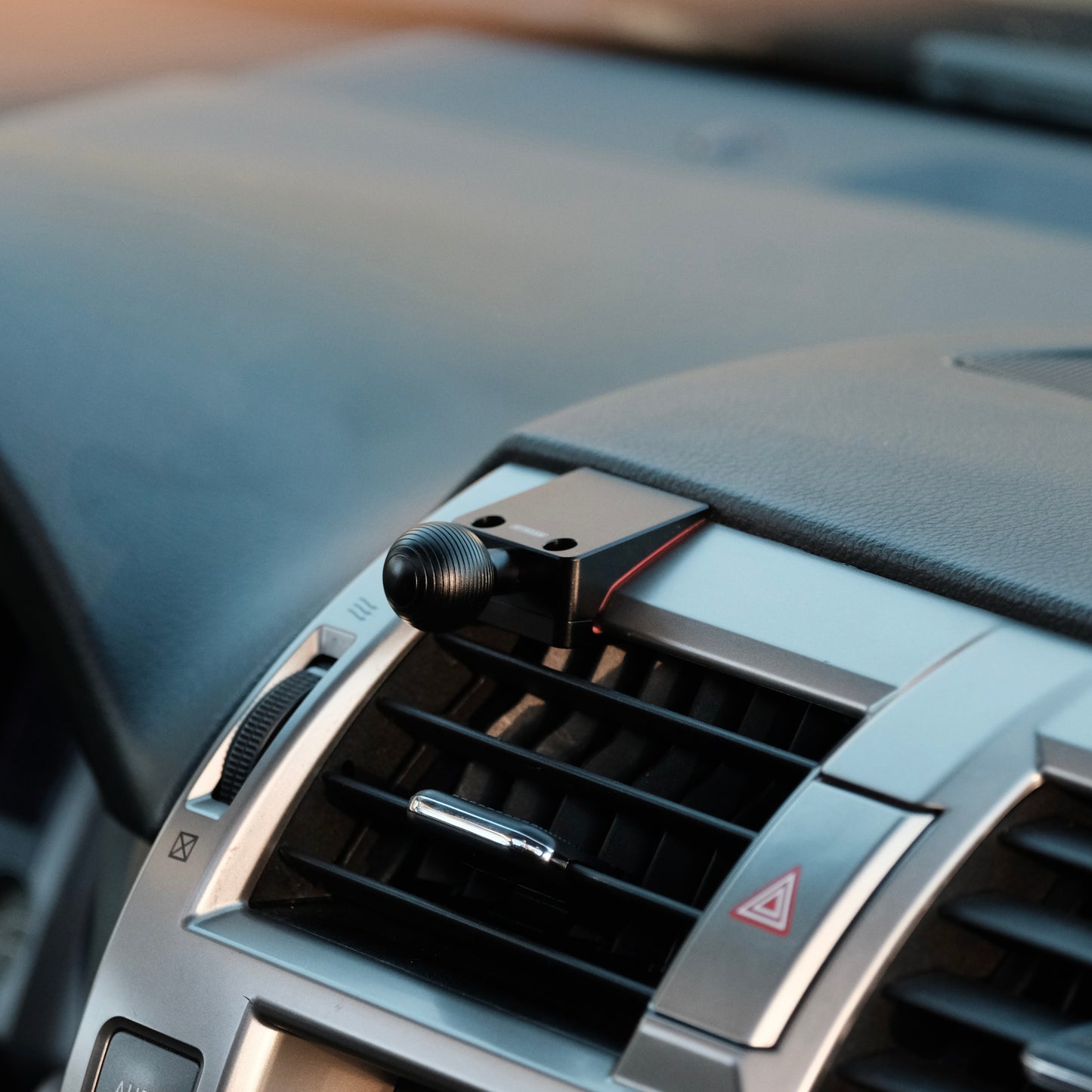 Image of Offroam Mounting Base installed securely in Lexus GX460 2010-2021. This premium all metal phone mounting base installs easily without drilling or glue. Perfect placement without blocking screens, driver view, or air flow.