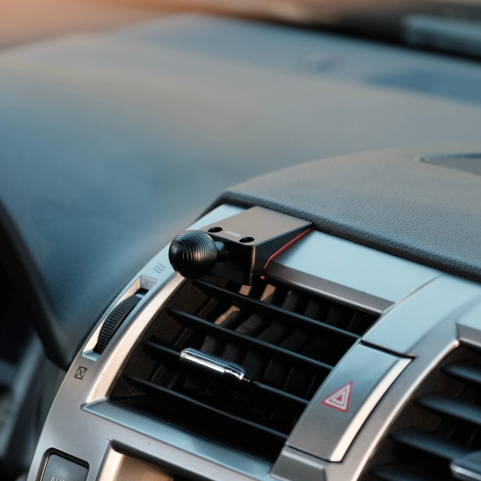 Image of Offroam Mounting Base installed securely in Lexus GX460 2010-2021. This premium all metal phone mounting base installs easily without drilling or glue. Perfect placement without blocking screens, driver view, or air flow.