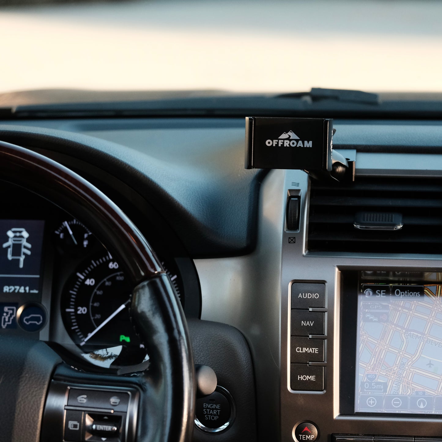 Image of Offroam Phone Mount installed securely in Lexus GX460 2010-2021. This premium phone mount installs easily without drilling or glue. Spring loaded Universal holder for use with any phone. Perfect placement without blocking screens, driver view, or air flow. Fully adjustable positioning.