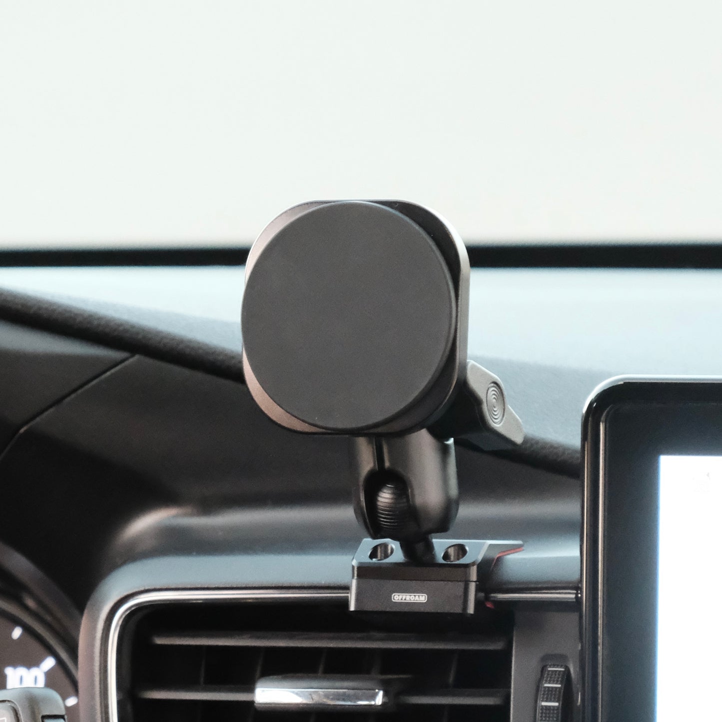Image of Offroam MagSafe-compatible Phone Mount installed securely in Ford Explorer 2020-2024. This premium phone mount installs easily without drilling or glue. High force magnets hold phone on any trail, road, or track. Perfect placement without blocking screens, driver view, or air flow. Fully adjustable positioning.