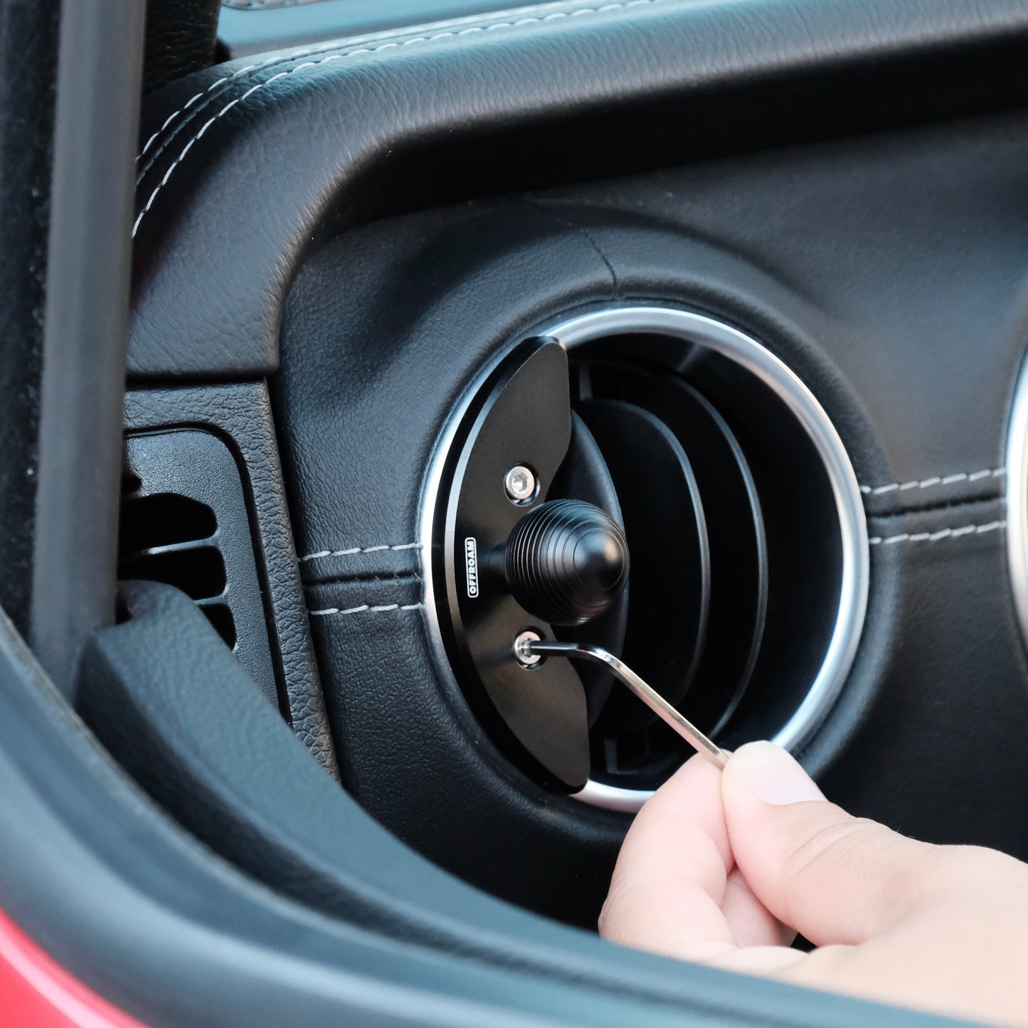 Image of Offroam Mounting Base installed securely in Jeep Wrangler 2018-2023 | Gladiator 2019-2023. This premium all metal phone mounting base installs easily without drilling or glue. Perfect placement without blocking screens, driver view, or air flow.