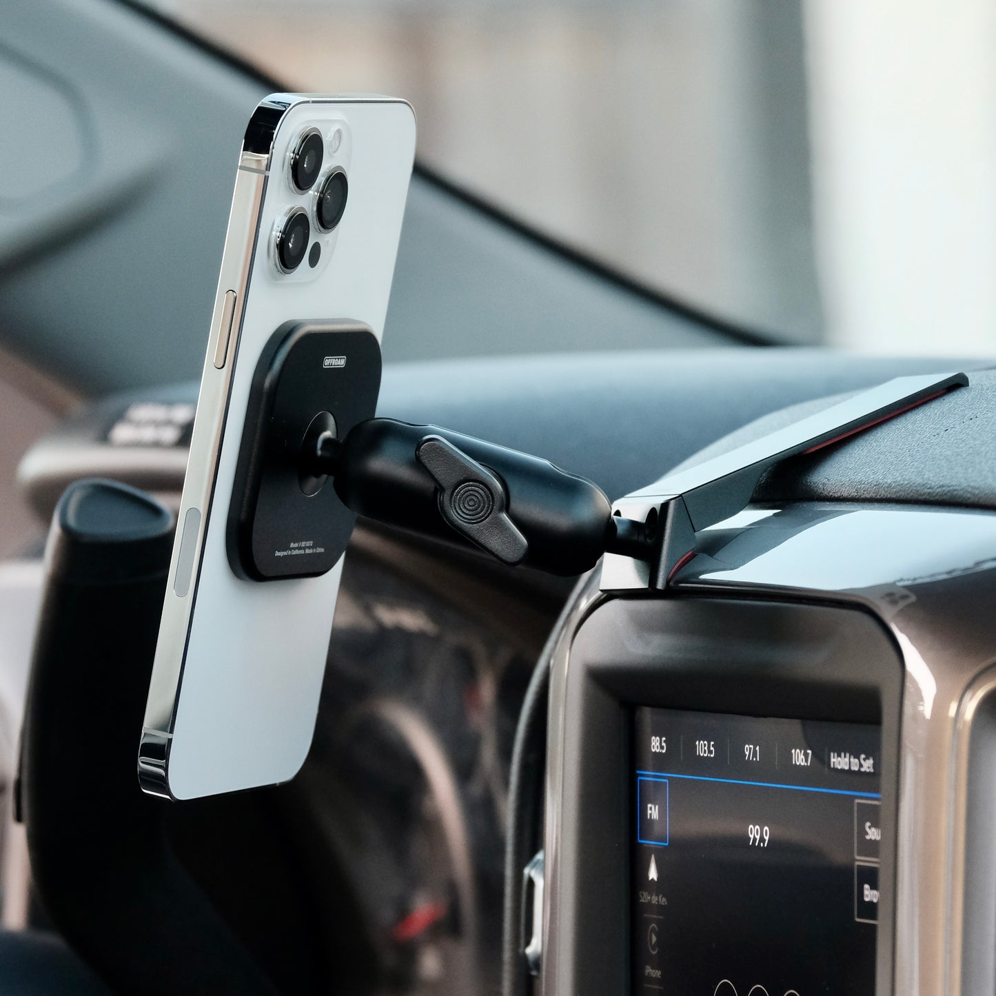 Image of Offroam MagSafe-compatible Phone Mount installed securely in Chevrolet Silverado 2019-2024 | Silverado HD 2020-2024 and GMC Sierra 1500 2019-2021 | Sierra HD 2020-2023 with 7-in.|8-in. display. This premium phone mount installs easily without drilling or glue. High force magnets hold phone on any trail, road, or track. Perfect placement without blocking screens, driver view, or air flow. Fully adjustable positioning.