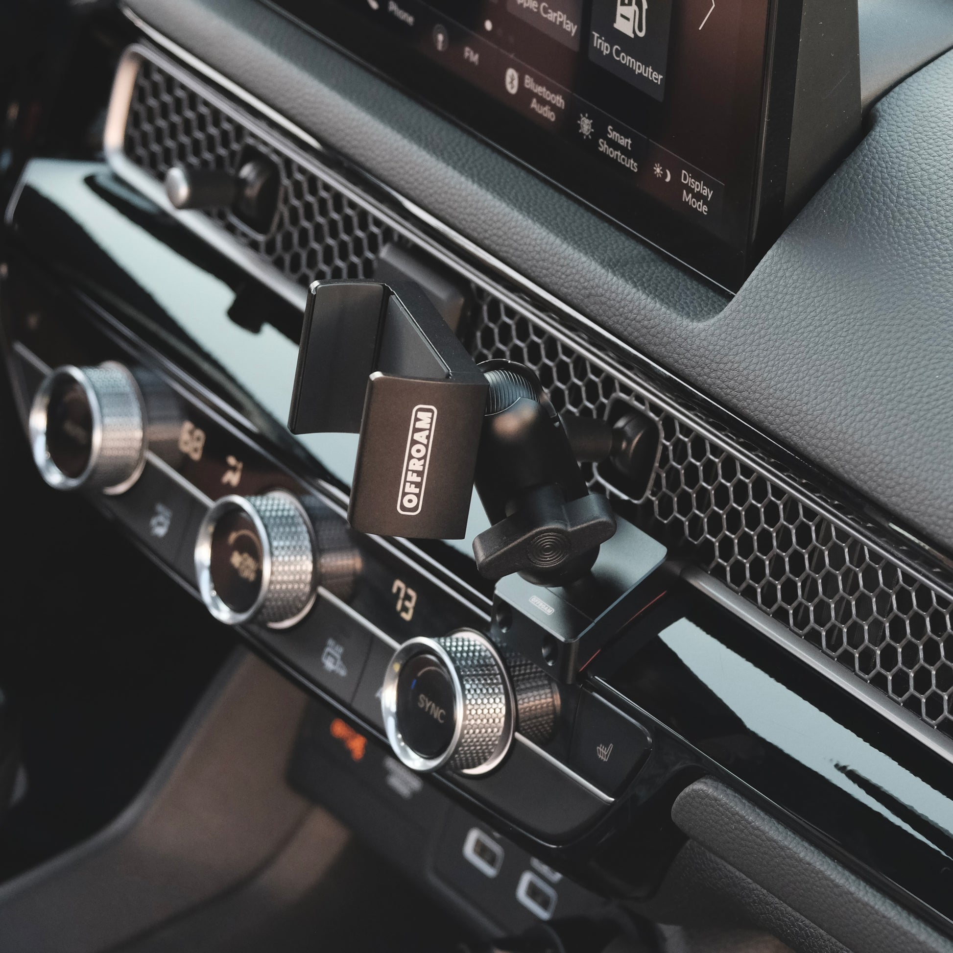 Image of Offroam Phone Mount installed securely in Honda Civic 2022-2026 | CR-V 2023-2026. This premium phone mount installs easily without drilling or glue. Spring loaded Universal holder for use with any phone. Perfect placement without blocking screens, driver view, or air flow. Fully adjustable positioning.