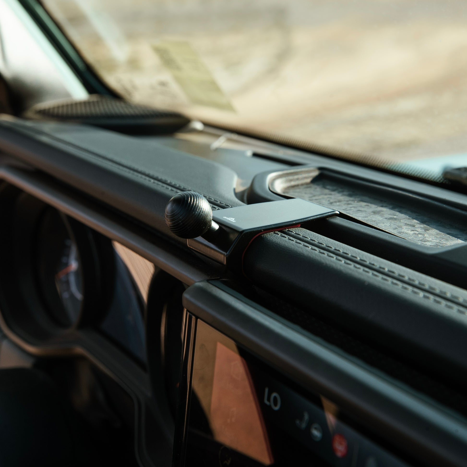 Image of Offroam Mounting Base installed securely in  Jeep Wrangler | Gladiator 2024-2025. This premium all metal phone mounting base installs easily without drilling or glue. Perfect placement without blocking screens, driver view, or air flow.