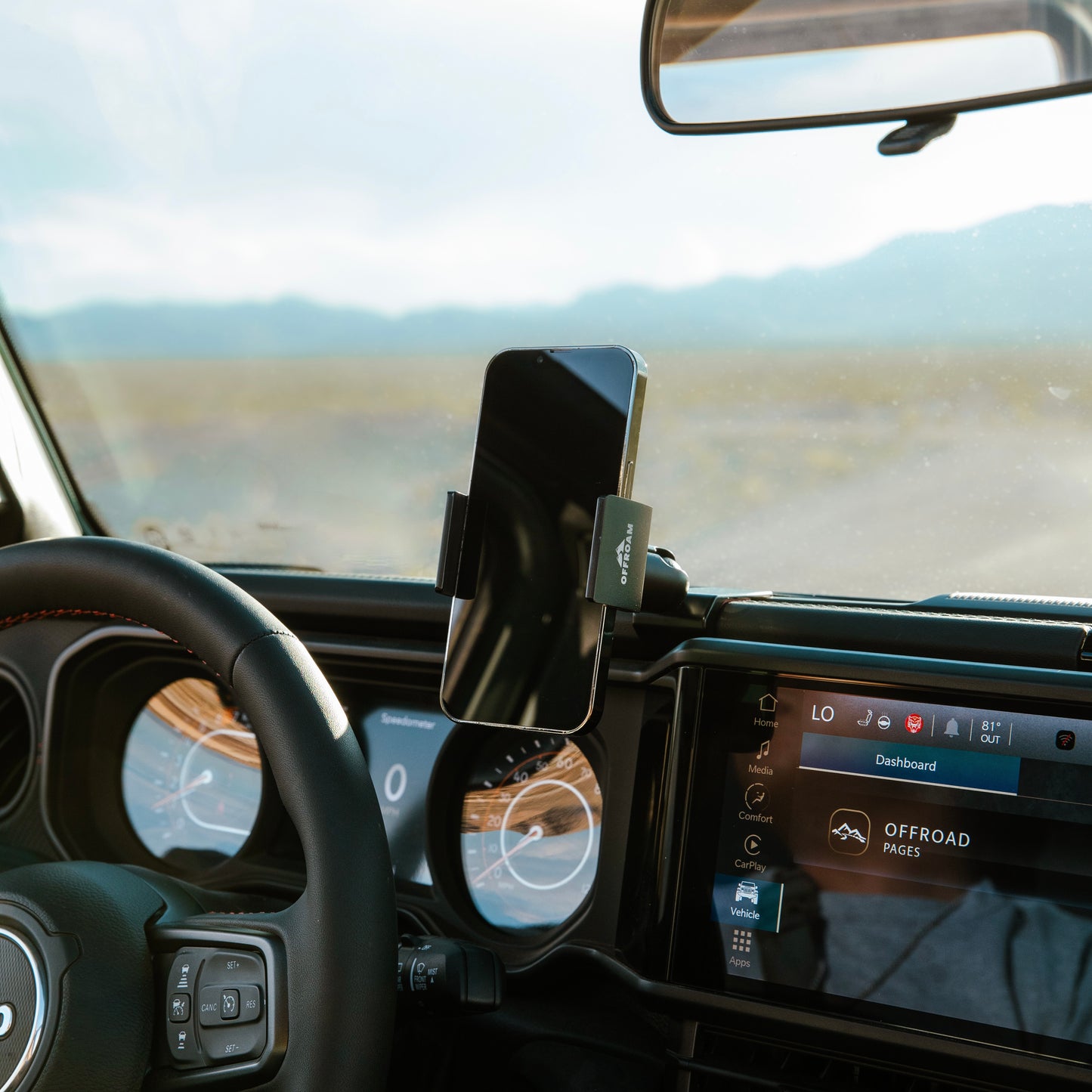 Image of Offroam Phone Mount installed securely in Jeep Wrangler | Gladiator 2024-2025. This premium phone mount installs easily without drilling or glue. Spring loaded Universal holder for use with any phone. Perfect placement without blocking screens, driver view, or air flow. Fully adjustable positioning.