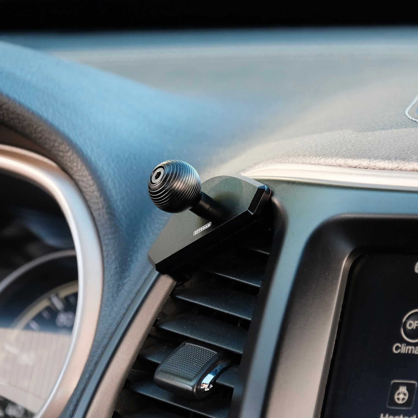Offroam mounting base with 20 mm ball installed cleanly on the dashboard off Jeep Cherokee 2014 to 2018 without blocking the air vent or louver, articulation forming a secure hold install installed on the driver side center air vent