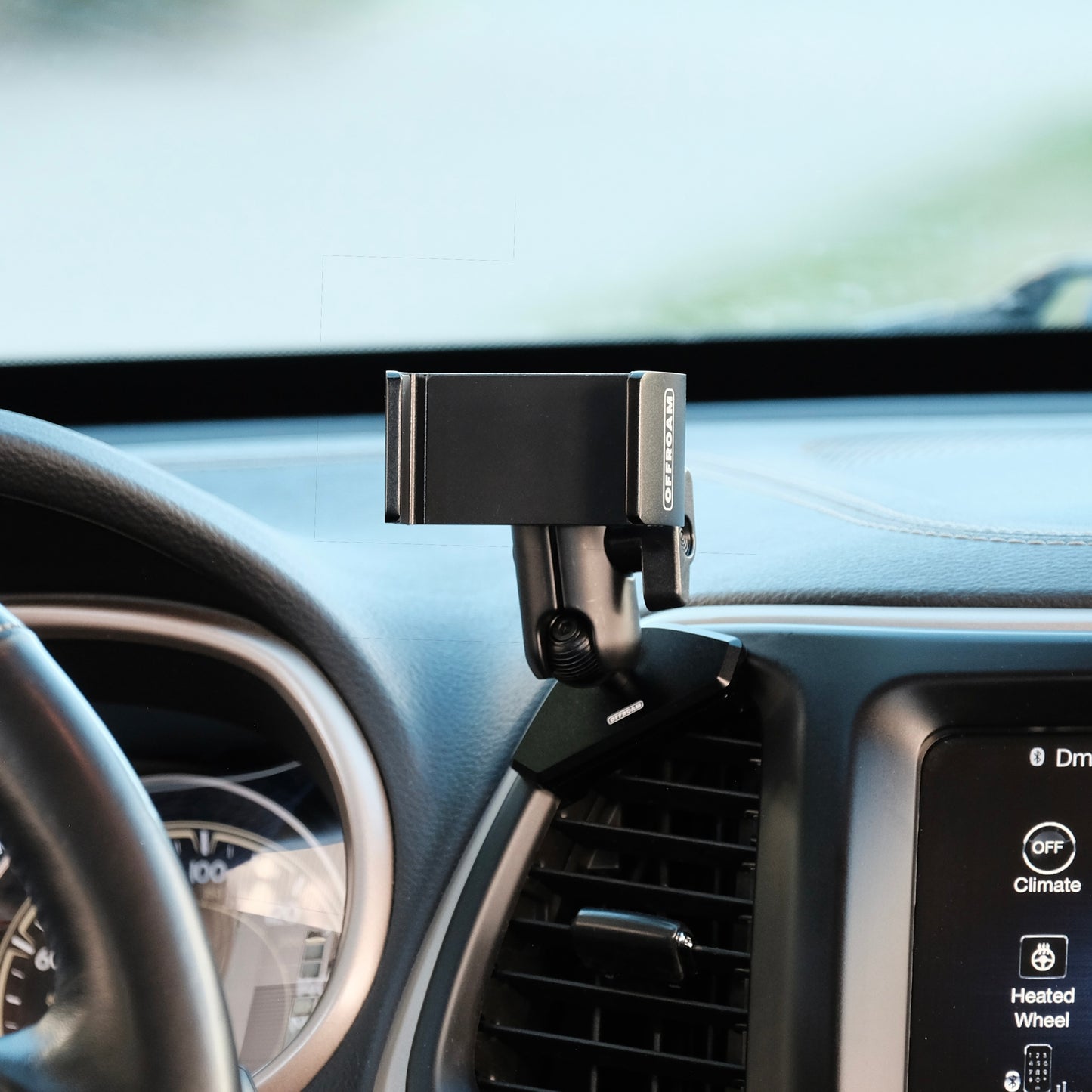 Offroam phone mount installed to the dashboard of Jeep Cherokee 2014 to 2018 held in place securely shown with a universal spring loaded phone holder for any phone. 4 x 4 trail rated secure hold.