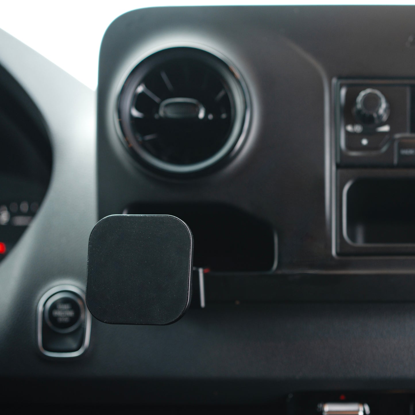 Image of Offroam MagSafe-compatible Phone Mount installed securely in Mercedes-Benz Sprinter 2019-2025. This premium phone mount installs easily without drilling or glue. High force magnets hold phone on any trail, road, or track. Perfect placement without blocking screens, driver view, or air flow. Fully adjustable positioning.