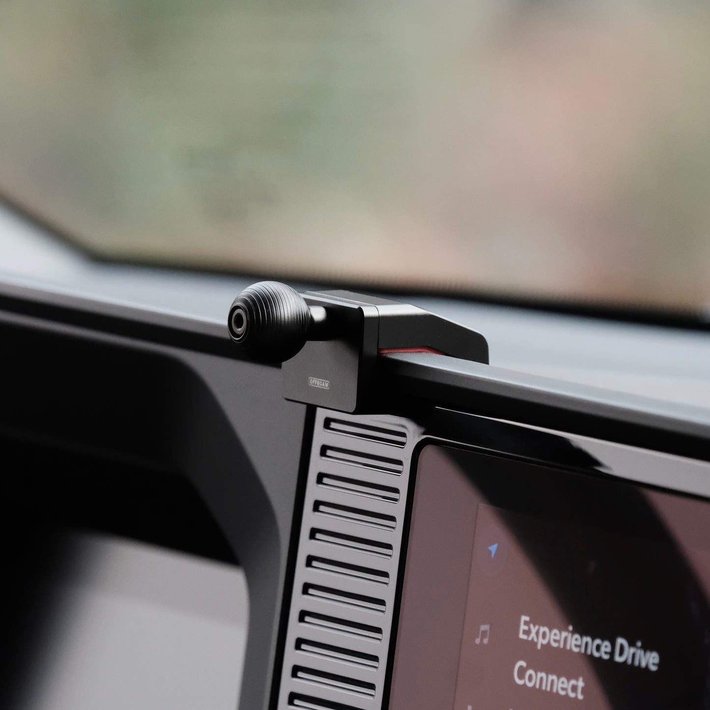 Image of Offroam Mounting Base installed securely in Toyota Land Cruiser 250 2024-2026. This premium all metal phone mounting base installs easily without drilling or glue. Perfect placement without blocking screens, driver view, or air flow.