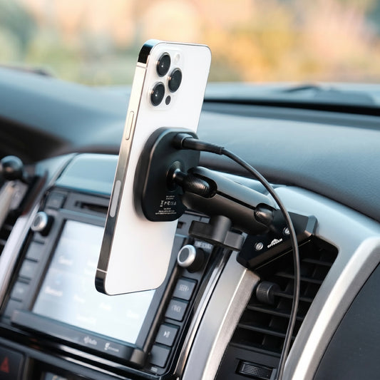 Image of Offroam MagSafe-compatible Phone Mount installed securely in Toyota Tacoma 2012-2015. This premium phone mount installs easily without drilling or glue. High force magnets hold phone on any trail, road, or track. Perfect placement without blocking screens, driver view, or air flow. Fully adjustable positioning.