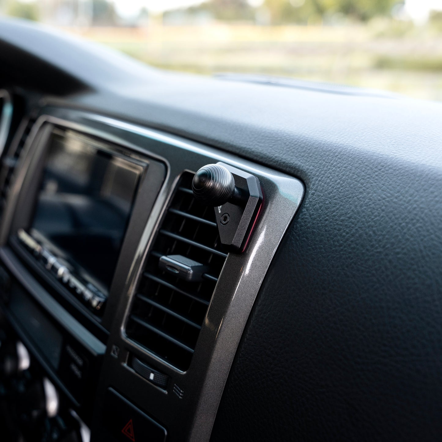 Image of Offroam Mounting Base installed securely in Toyota 4Runner 2003-2009. This premium all metal phone mounting base installs easily without drilling or glue. Perfect placement without blocking screens, driver view, or air flow.