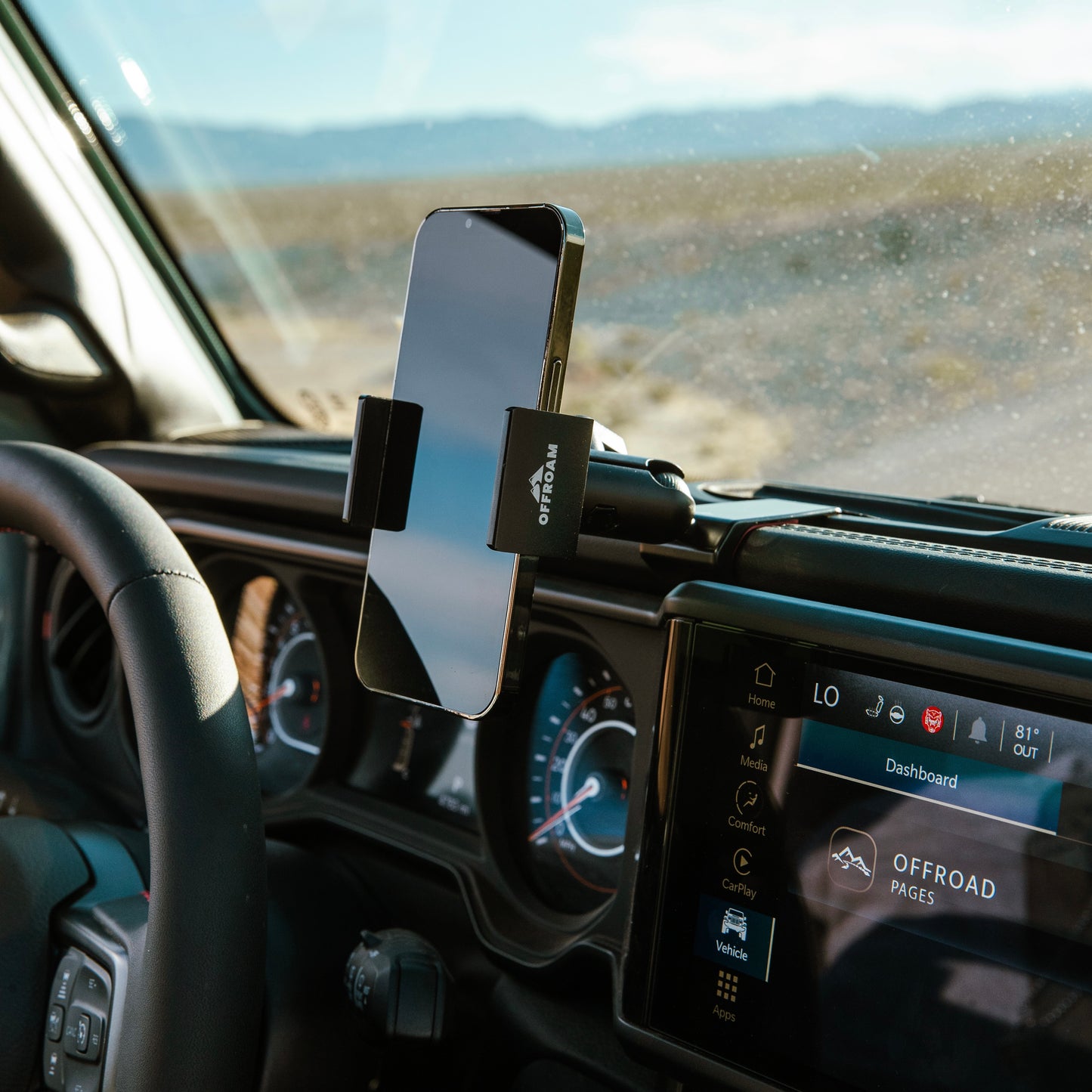 Image of Offroam Phone Mount installed securely in Jeep Wrangler | Gladiator 2024-2025. This premium phone mount installs easily without drilling or glue. Spring loaded Universal holder for use with any phone. Perfect placement without blocking screens, driver view, or air flow. Fully adjustable positioning.