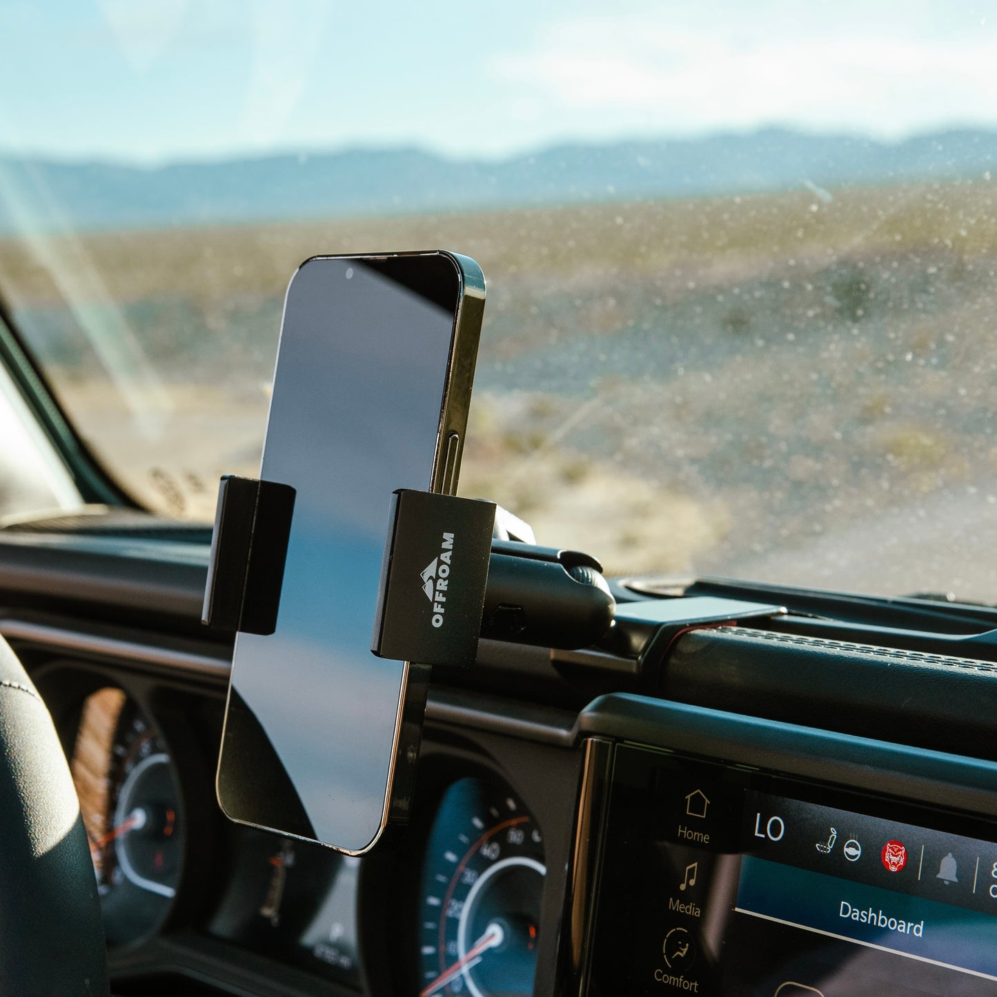 Image of Offroam Phone Mount installed securely in Jeep Wrangler | Gladiator 2024-2025. This premium phone mount installs easily without drilling or glue. Spring loaded Universal holder for use with any phone. Perfect placement without blocking screens, driver view, or air flow. Fully adjustable positioning.