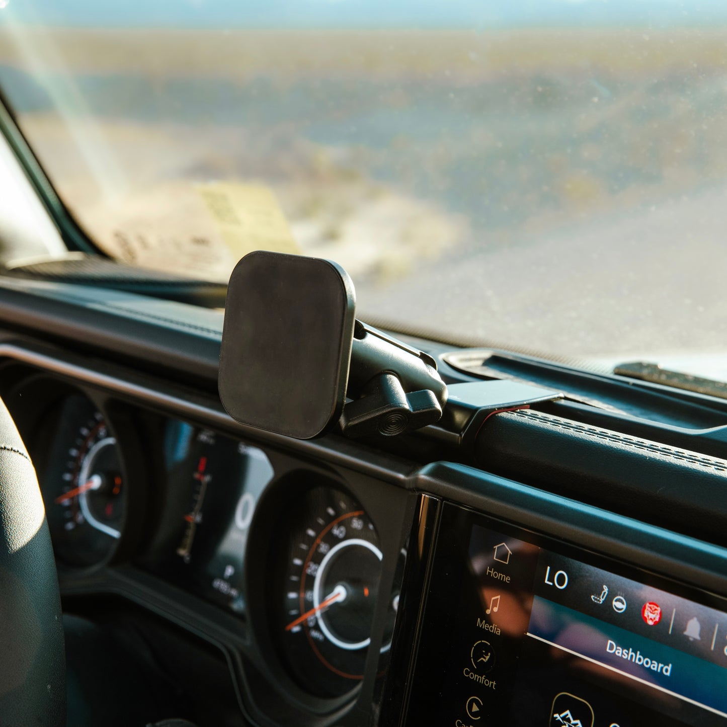 Image of Offroam MagSafe-compatible Phone Mount installed securely in Jeep Wrangler | Gladiator 2024-2025. This premium phone mount installs easily without drilling or glue. High force magnets hold phone on any trail, road, or track. Perfect placement without blocking screens, driver view, or air flow. Fully adjustable positioning.