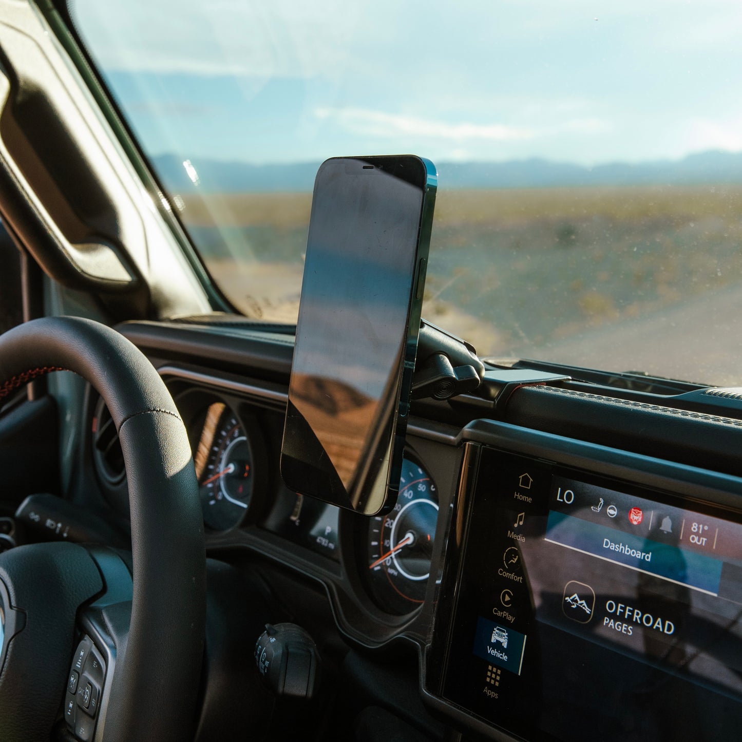 Image of Offroam MagSafe-compatible Phone Mount installed securely in Jeep Wrangler | Gladiator 2024-2025. This premium phone mount installs easily without drilling or glue. High force magnets hold phone on any trail, road, or track. Perfect placement without blocking screens, driver view, or air flow. Fully adjustable positioning.