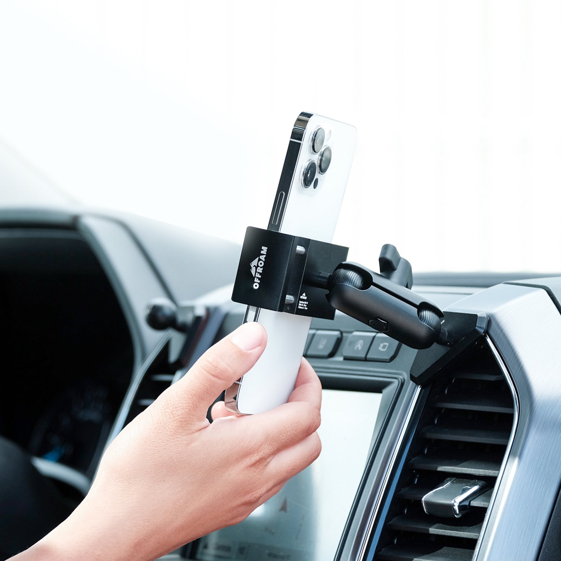 Image of Offroam Phone Mount installed securely in Ford F-150 2015-2020 | Super Duty 2017-2021 & 2022 (XL and XLT) | Expedition 2018-2021. This premium phone mount installs easily without drilling or glue. Spring loaded Universal holder for use with any phone. Perfect placement without blocking screens, driver view, or air flow. Fully adjustable positioning.