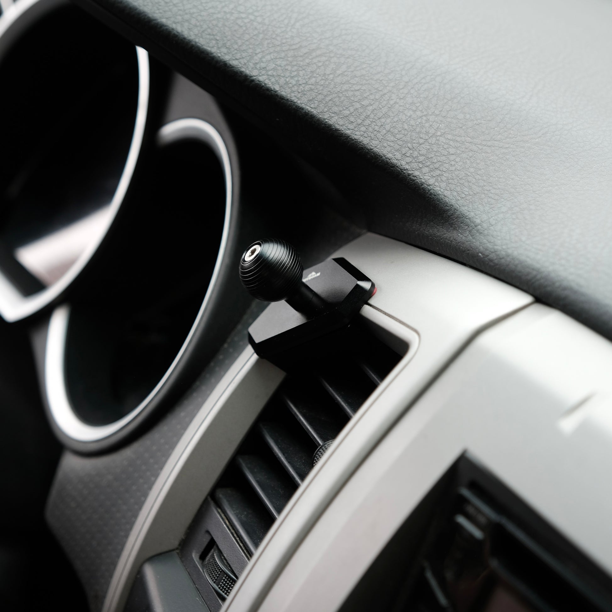 Image of Offroam Mounting Base installed securely in Toyota Tacoma 2005-2011. This premium all metal phone mounting base installs easily without drilling or glue. Perfect placement without blocking screens, driver view, or air flow.