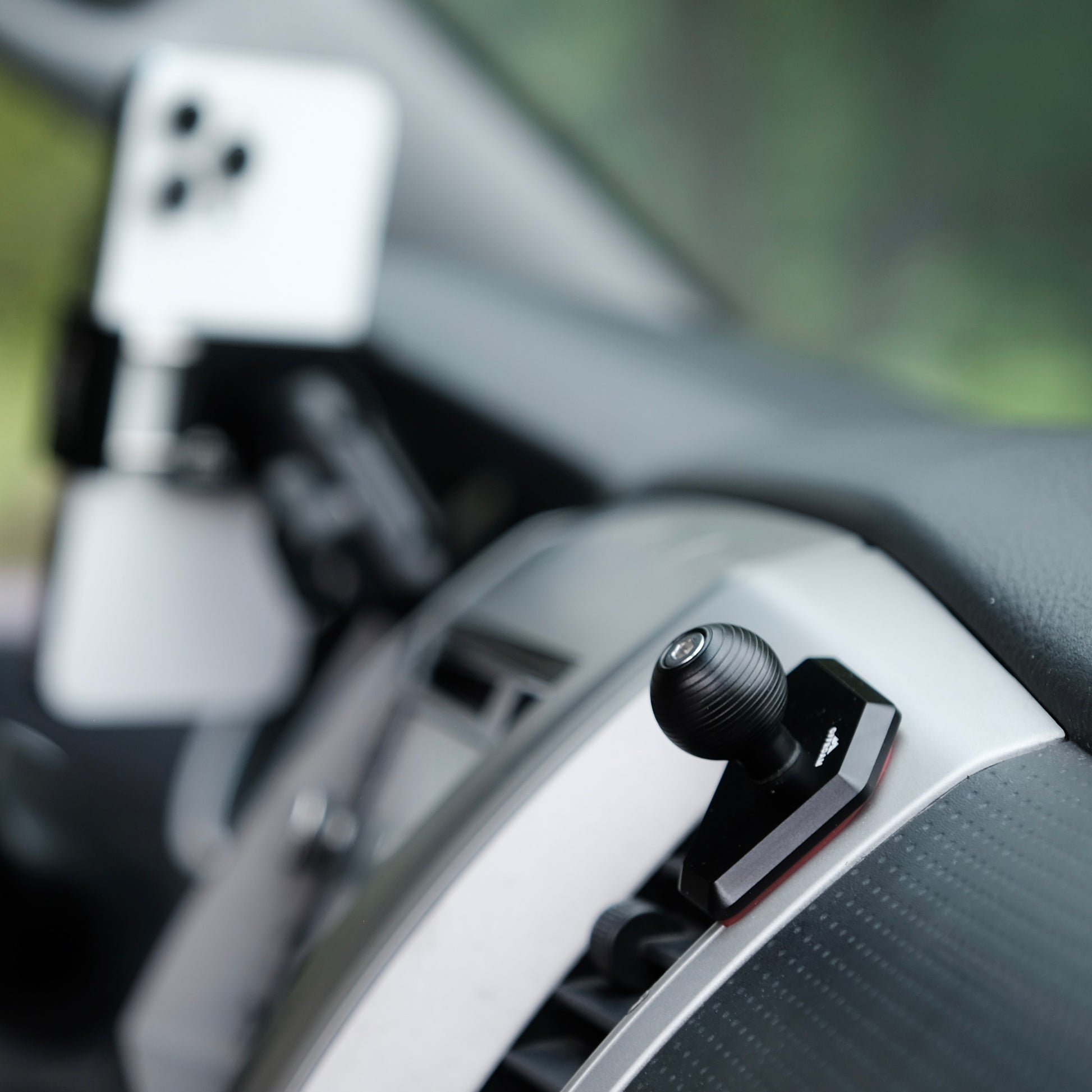 Image of Offroam Mounting Base installed securely in Toyota Tacoma 2005-2011. This premium all metal phone mounting base installs easily without drilling or glue. Perfect placement without blocking screens, driver view, or air flow.