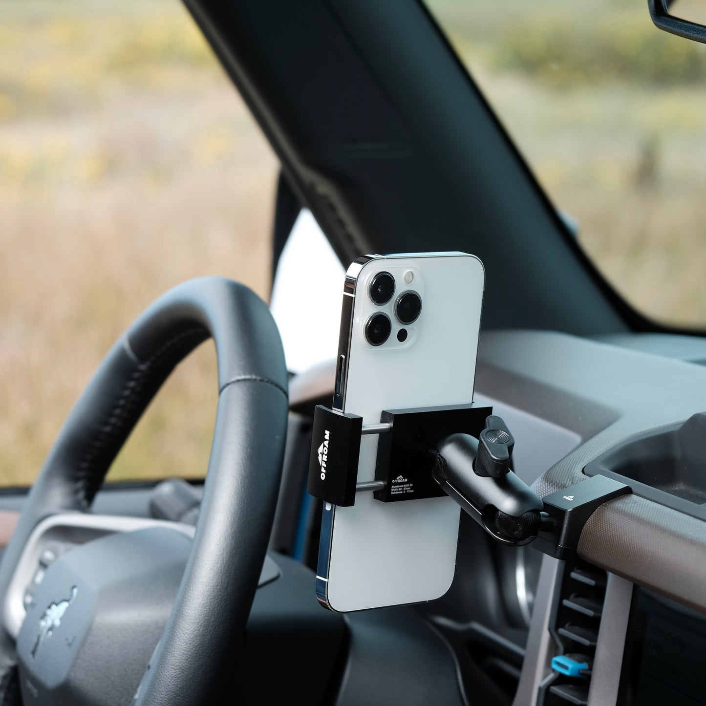 Image of Offroam Phone Mount installed securely in Ford Bronco 2021-2025. This premium phone mount installs easily without drilling or glue. Spring loaded Universal holder for use with any phone. Perfect placement without blocking screens, driver view, or air flow. Fully adjustable positioning.