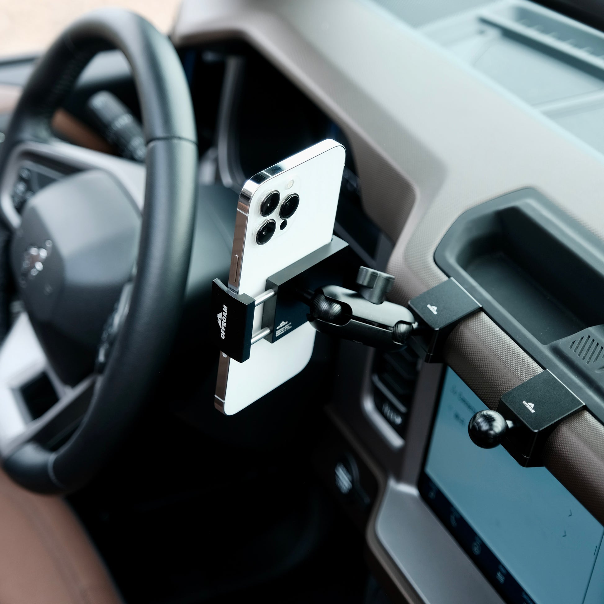 Image of Offroam Phone Mount installed securely in Ford Bronco 2021-2025. This premium phone mount installs easily without drilling or glue. Spring loaded Universal holder for use with any phone. Perfect placement without blocking screens, driver view, or air flow. Fully adjustable positioning.