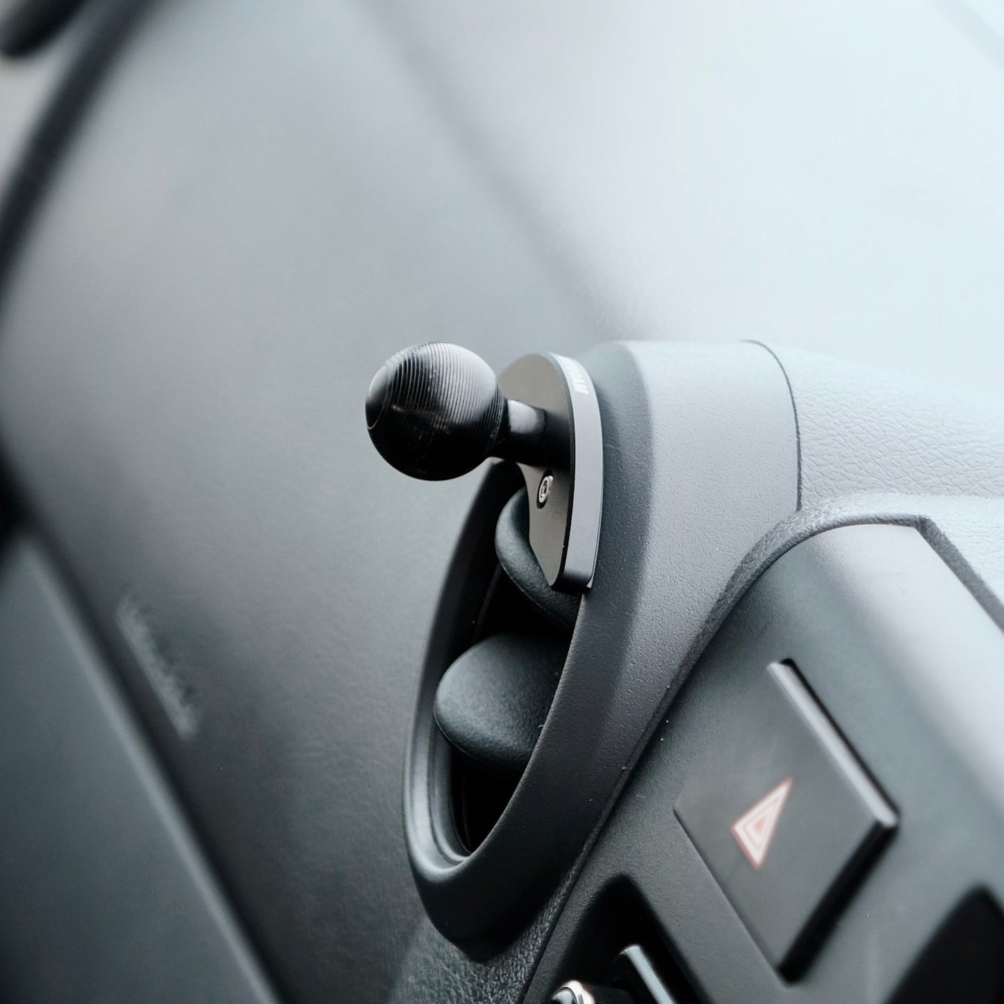 Image of Offroam Mounting Base installed securely in Toyota Land Cruiser 70 2007-2026. This premium all metal phone mounting base installs easily without drilling or glue. Perfect placement without blocking screens, driver view, or air flow.