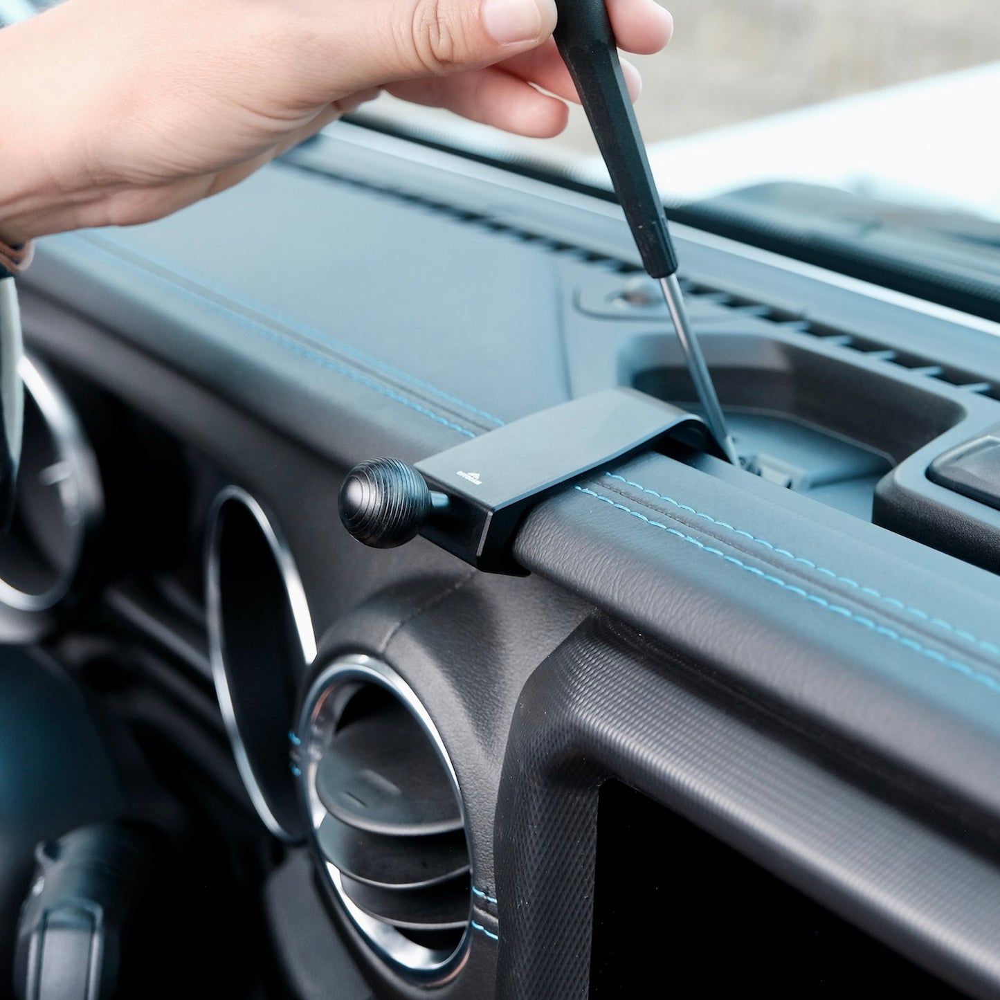 Image of Offroam Mounting Base installed securely in Jeep Wrangler 2018-2023 | Gladiator 2019-2023. This premium all metal phone mounting base installs easily without drilling or glue. Perfect placement without blocking screens, driver view, or air flow.