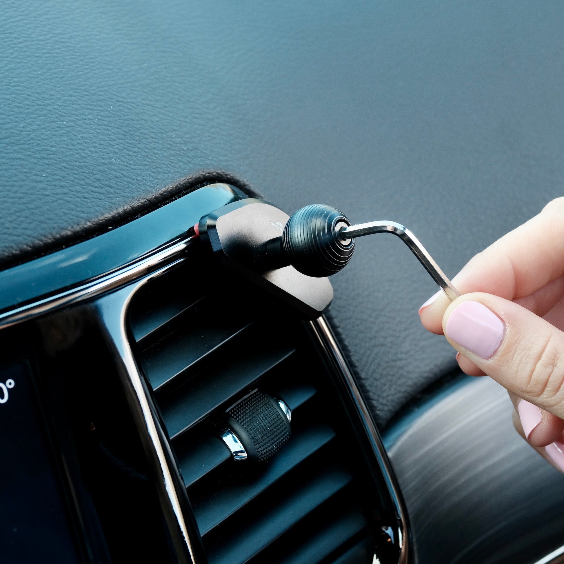 Image of Offroam Mounting Base installed securely in Jeep Grand Cherokee WK2 2014-2022. This premium all metal phone mounting base installs easily without drilling or glue. Perfect placement without blocking screens, driver view, or air flow.