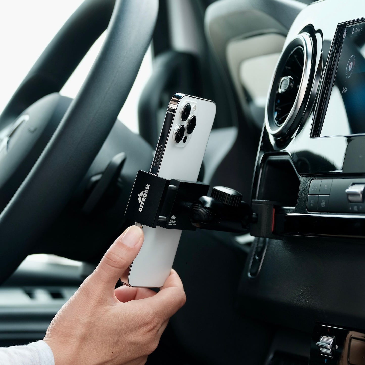 Image of Offroam Phone Mount installed securely in Mercedes-Benz Sprinter 2019-2025. This premium phone mount installs easily without drilling or glue. Spring loaded Universal holder for use with any phone. Perfect placement without blocking screens, driver view, or air flow. Fully adjustable positioning.