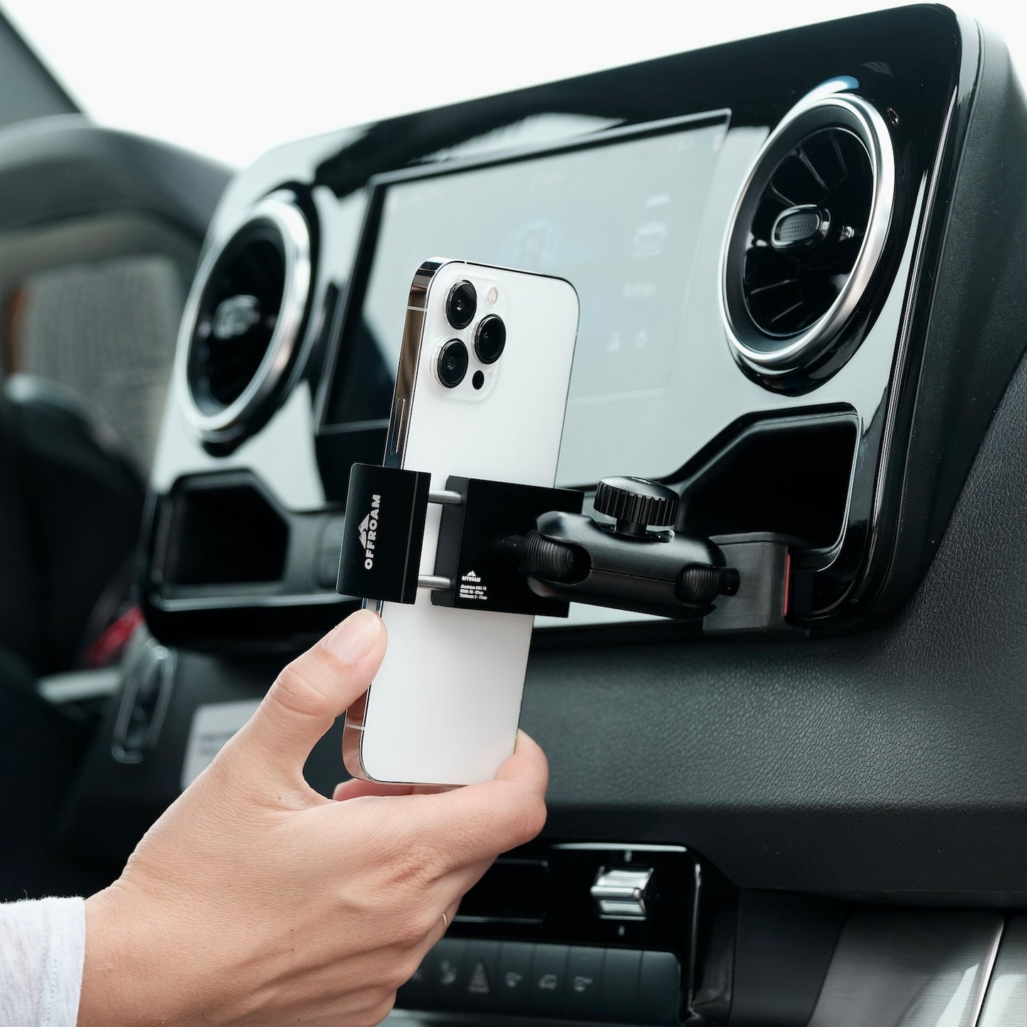 Image of Offroam Phone Mount installed securely in Mercedes-Benz Sprinter 2019-2025. This premium phone mount installs easily without drilling or glue. Spring loaded Universal holder for use with any phone. Perfect placement without blocking screens, driver view, or air flow. Fully adjustable positioning.