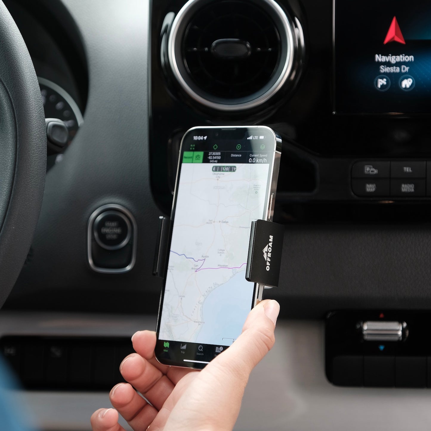 Image of Offroam Phone Mount installed securely in Mercedes-Benz Sprinter 2019-2025. This premium phone mount installs easily without drilling or glue. Spring loaded Universal holder for use with any phone. Perfect placement without blocking screens, driver view, or air flow. Fully adjustable positioning.