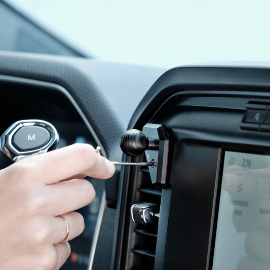 Image of Offroam Mounting Base installed securely in Ford F-150 2021-2025 | F-250/F-350 2023-2025 | F-150 Lightning (XL & PRO) 2022-2025. This premium all metal phone mounting base installs easily without drilling or glue. Perfect placement without blocking screens, driver view, or air flow.