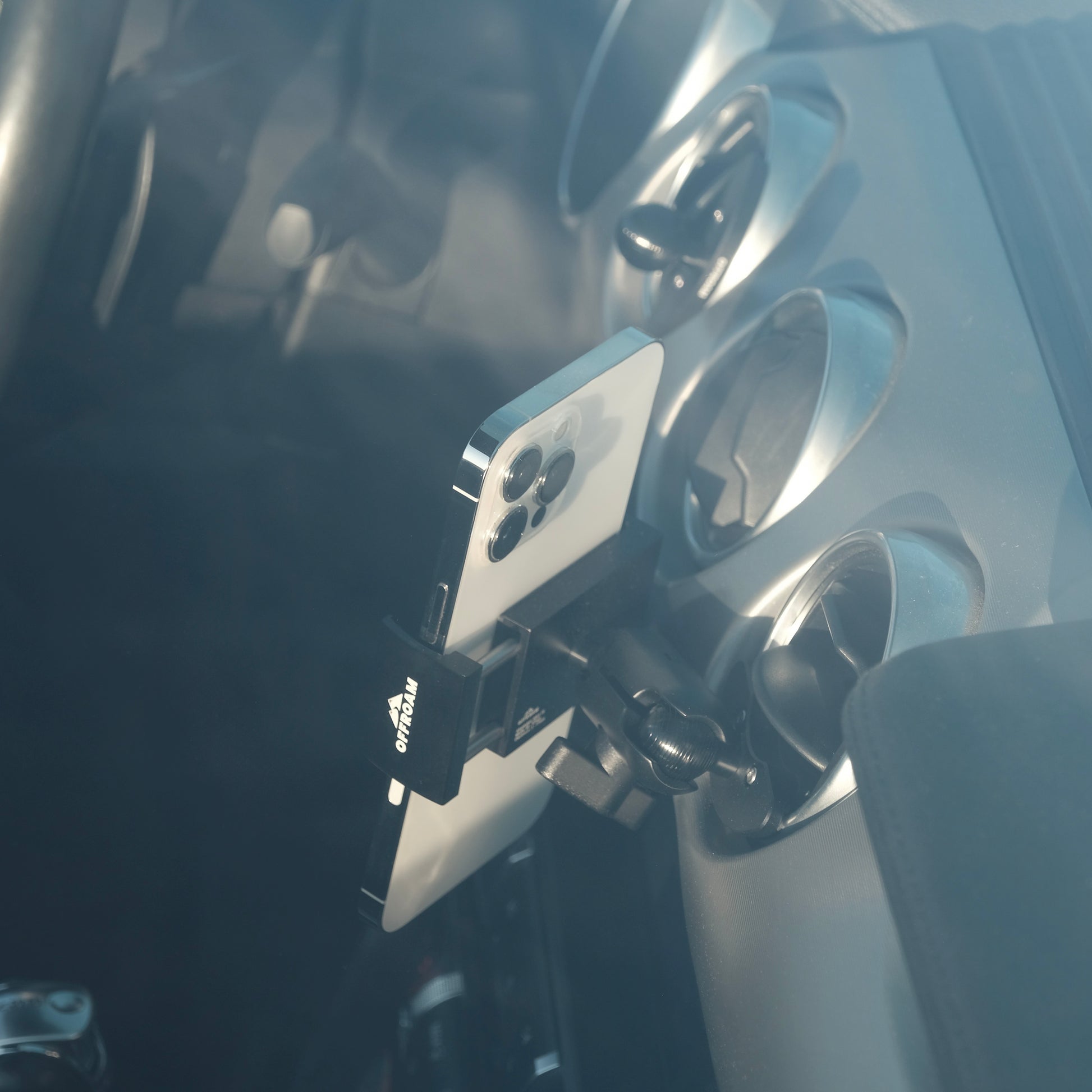 Image of Offroam Phone Mount installed securely in Ford Mustang 2015-2023. This premium phone mount installs easily without drilling or glue. Spring loaded Universal holder for use with any phone. Perfect placement without blocking screens, driver view, or air flow. Fully adjustable positioning.