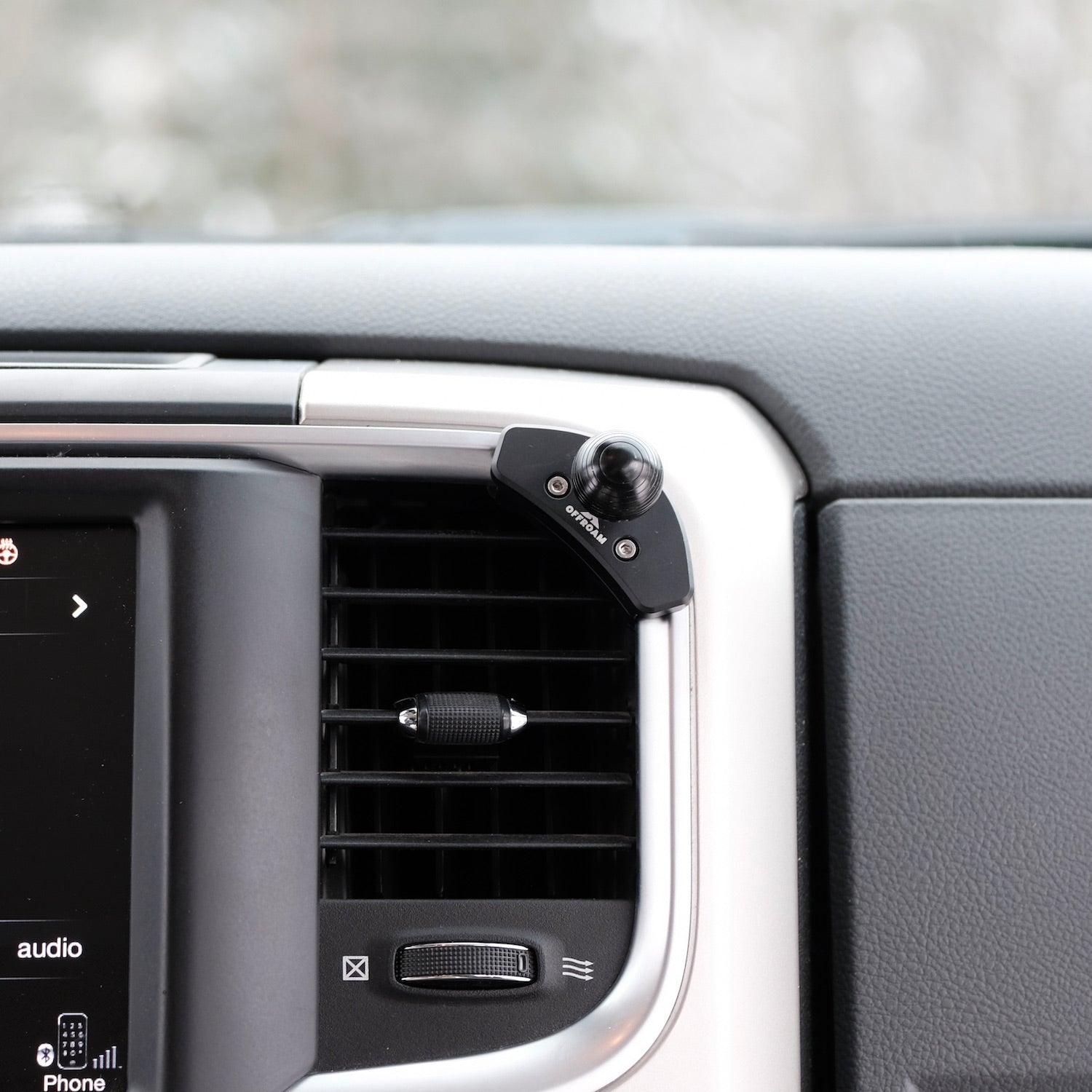 Image of Offroam Mounting Base installed securely in Ram 1500/2500/3500 2013-2018 & Ram Classic 2019-2024. This premium all metal phone mounting base installs easily without drilling or glue. Perfect placement without blocking screens, driver view, or air flow.