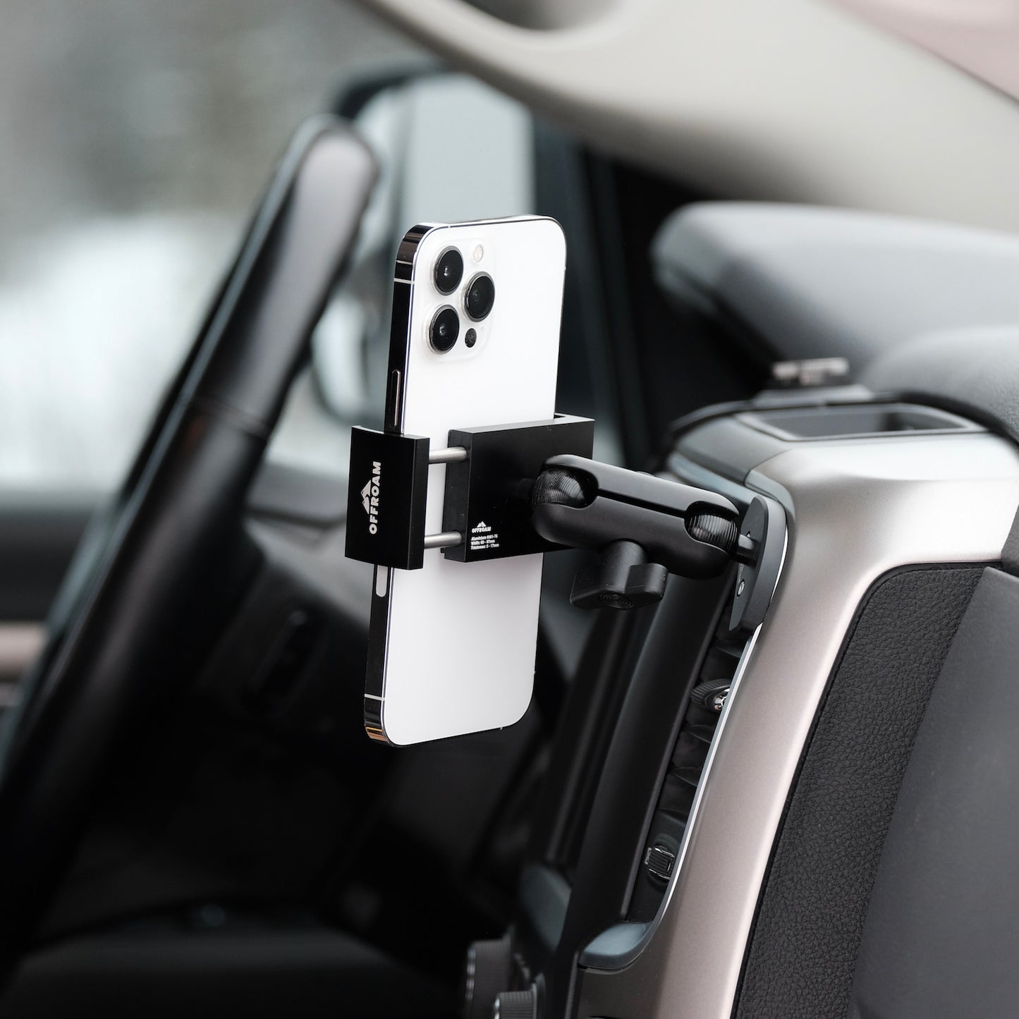 Image of Offroam Phone Mount installed securely in Ram 1500/2500/3500 2013-2018 & Ram Classic 2019-2024. This premium phone mount installs easily without drilling or glue. Spring loaded Universal holder for use with any phone. Perfect placement without blocking screens, driver view, or air flow. Fully adjustable positioning.