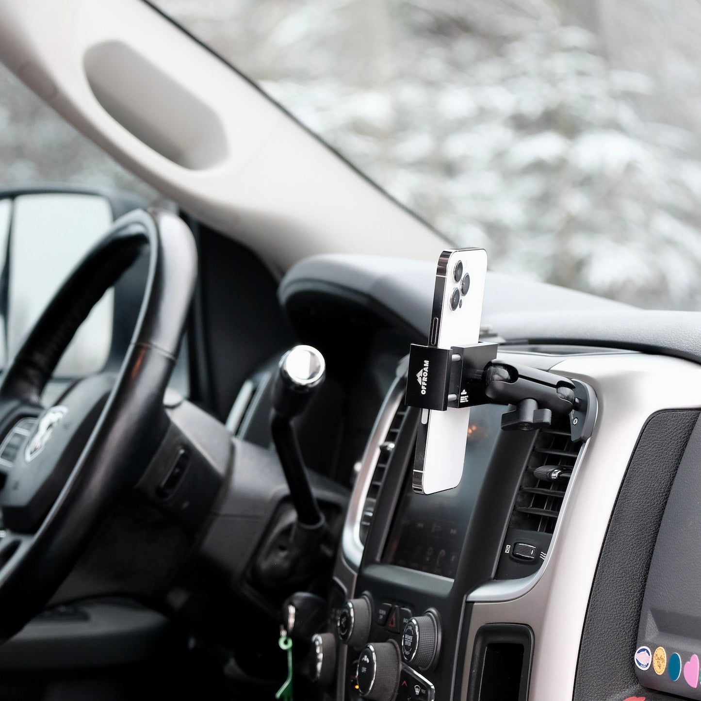 Image of Offroam Phone Mount installed securely in Ram 1500/2500/3500 2013-2018 & Ram Classic 2019-2024. This premium phone mount installs easily without drilling or glue. Spring loaded Universal holder for use with any phone. Perfect placement without blocking screens, driver view, or air flow. Fully adjustable positioning.