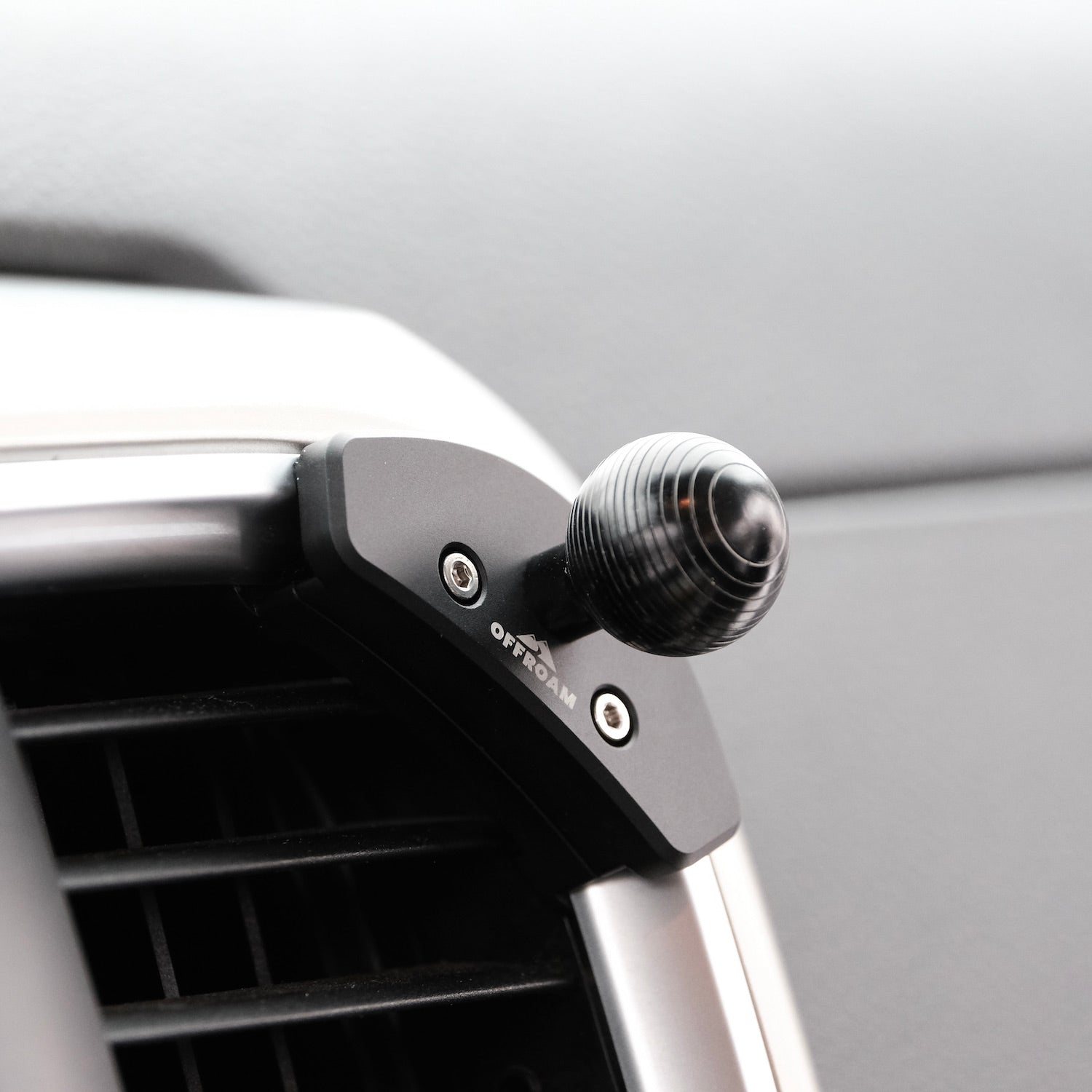 Image of Offroam Mounting Base installed securely in Ram 1500/2500/3500 2013-2018 & Ram Classic 2019-2024. This premium all metal phone mounting base installs easily without drilling or glue. Perfect placement without blocking screens, driver view, or air flow.