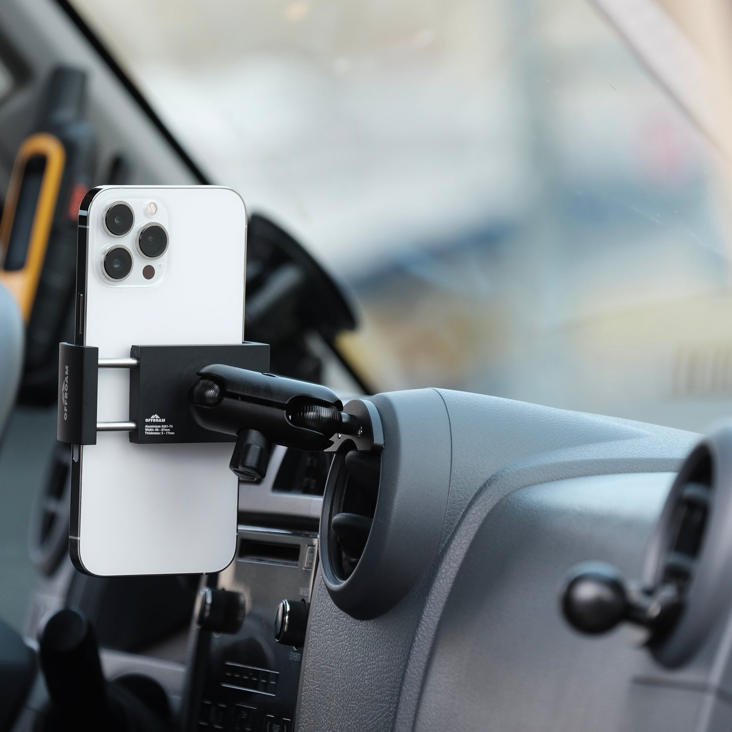 Image of Offroam Phone Mount installed securely in Toyota Land Cruiser 70 2007-2026. This premium phone mount installs easily without drilling or glue. Spring loaded Universal holder for use with any phone. Perfect placement without blocking screens, driver view, or air flow. Fully adjustable positioning.