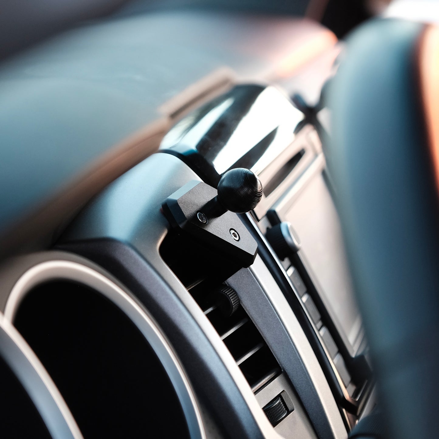 Image of Offroam Mounting Base installed securely in Toyota Tacoma 2012-2015. This premium all metal phone mounting base installs easily without drilling or glue. Perfect placement without blocking screens, driver view, or air flow.