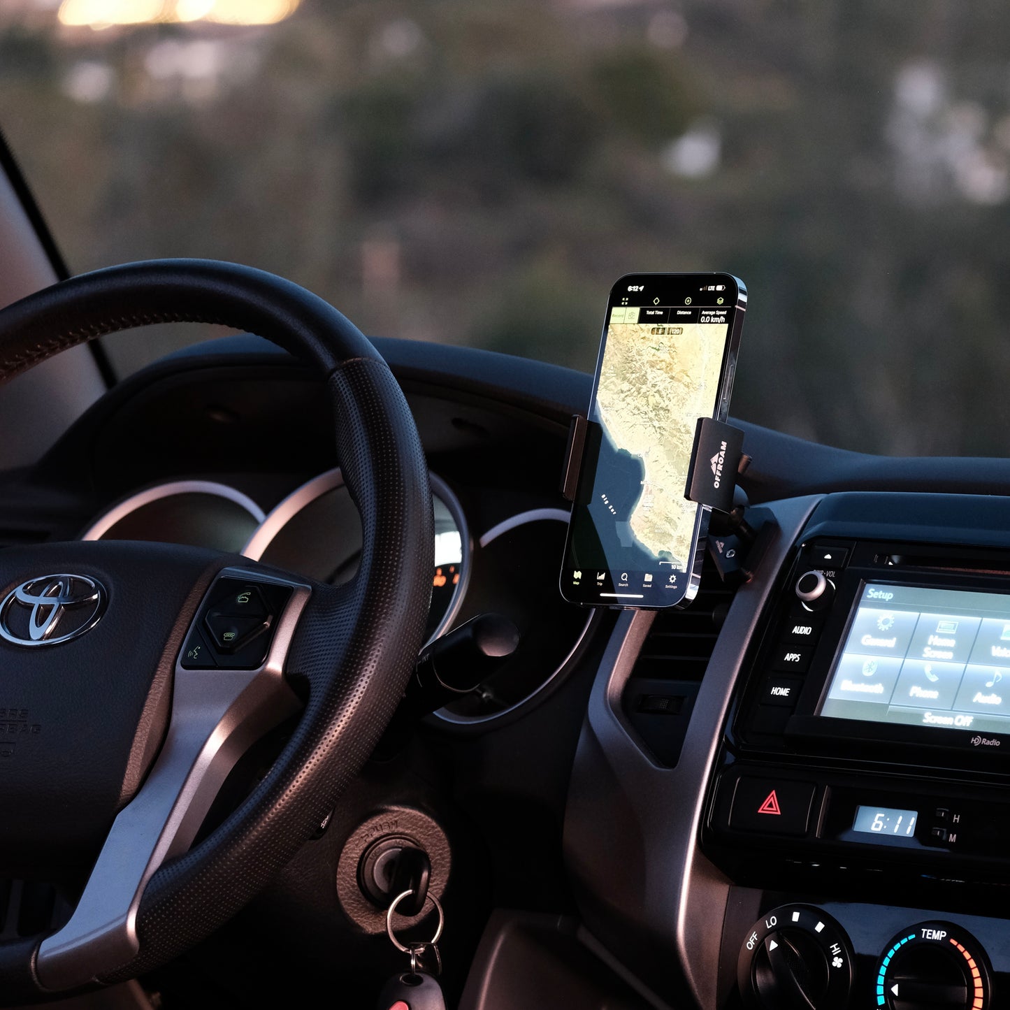 Image of Offroam Phone Mount installed securely in Toyota Tacoma 2012-2015. This premium phone mount installs easily without drilling or glue. Spring loaded Universal holder for use with any phone. Perfect placement without blocking screens, driver view, or air flow. Fully adjustable positioning.
