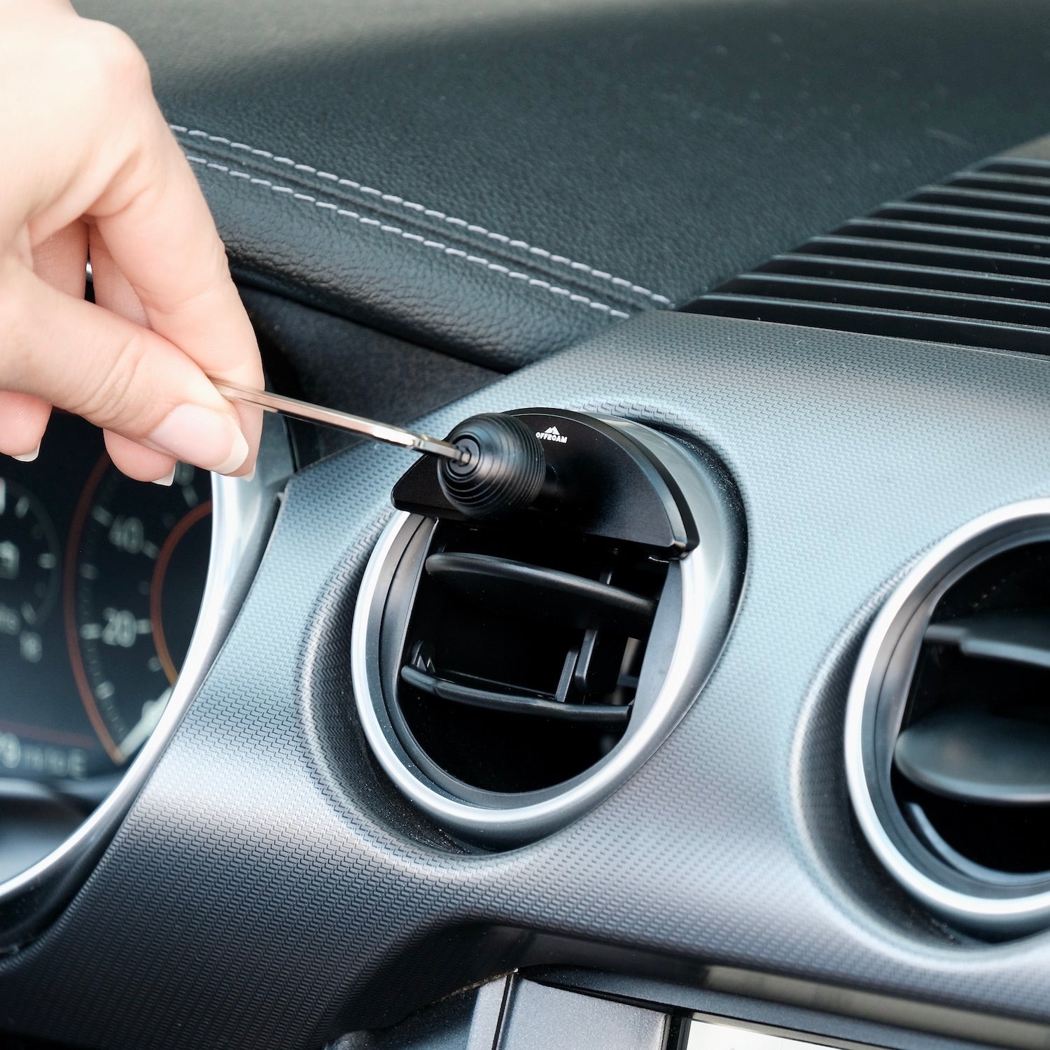 Image of Offroam Mounting Base installed securely in Ford Mustang 2015-2023. This premium all metal phone mounting base installs easily without drilling or glue. Perfect placement without blocking screens, driver view, or air flow.