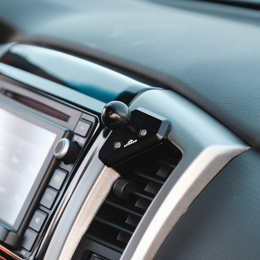Image of Offroam Mounting Base installed securely in Toyota Tacoma 2012-2015. This premium all metal phone mounting base installs easily without drilling or glue. Perfect placement without blocking screens, driver view, or air flow.