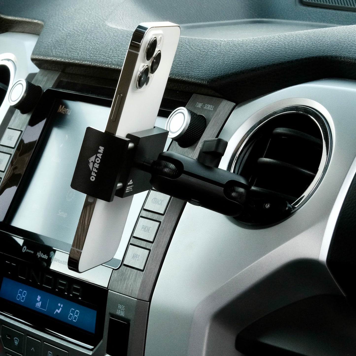 Image of Offroam Phone Mount installed securely in Toyota Tacoma 2016-2023 | Tundra 2014-2021. This premium phone mount installs easily without drilling or glue. Spring loaded Universal holder for use with any phone. Perfect placement without blocking screens, driver view, or air flow. Fully adjustable positioning.