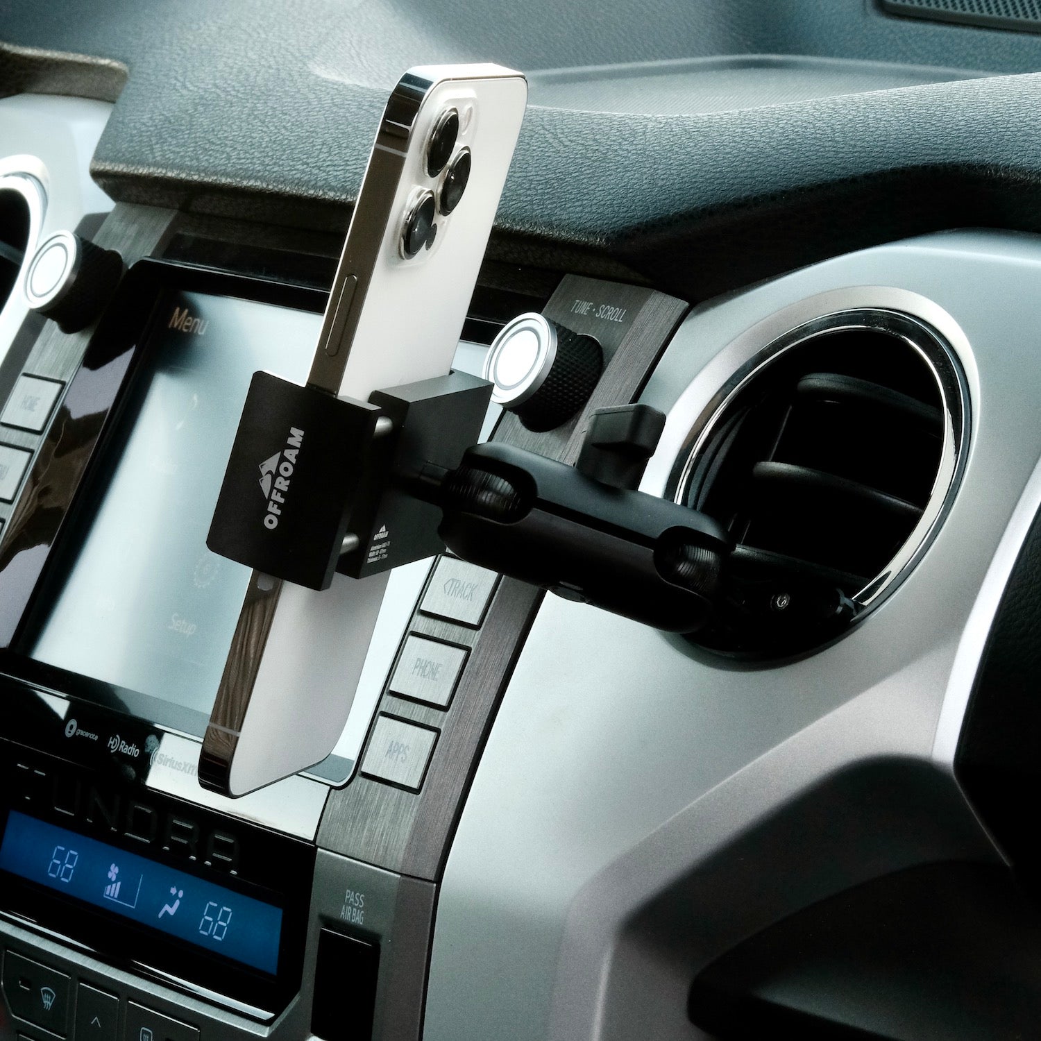 Image of Offroam Phone Mount installed securely in Toyota Tacoma 2016-2023 | Tundra 2014-2021. This premium phone mount installs easily without drilling or glue. Spring loaded Universal holder for use with any phone. Perfect placement without blocking screens, driver view, or air flow. Fully adjustable positioning.