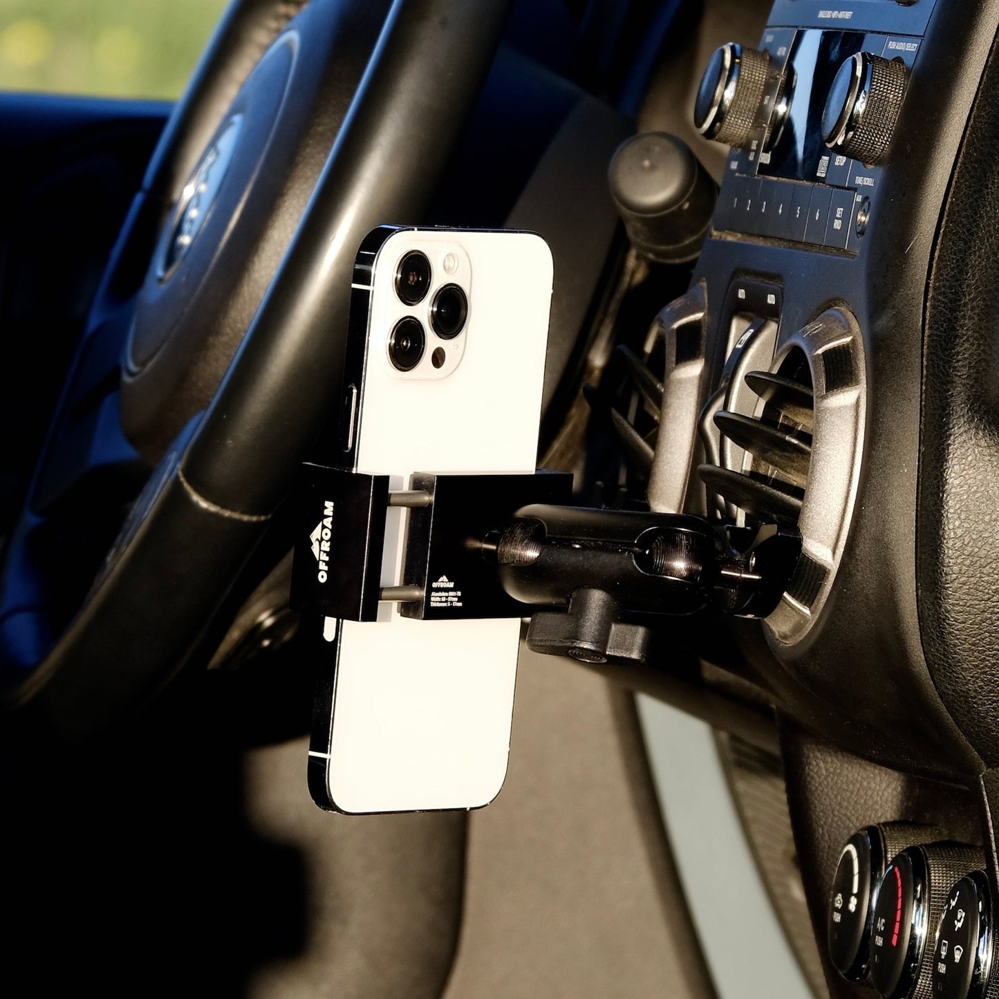 Image of Offroam Phone Mount installed securely in Jeep Wrangler JK 2011-2018. This premium phone mount installs easily without drilling or glue. Spring loaded Universal holder for use with any phone. Perfect placement without blocking screens, driver view, or air flow. Fully adjustable positioning.