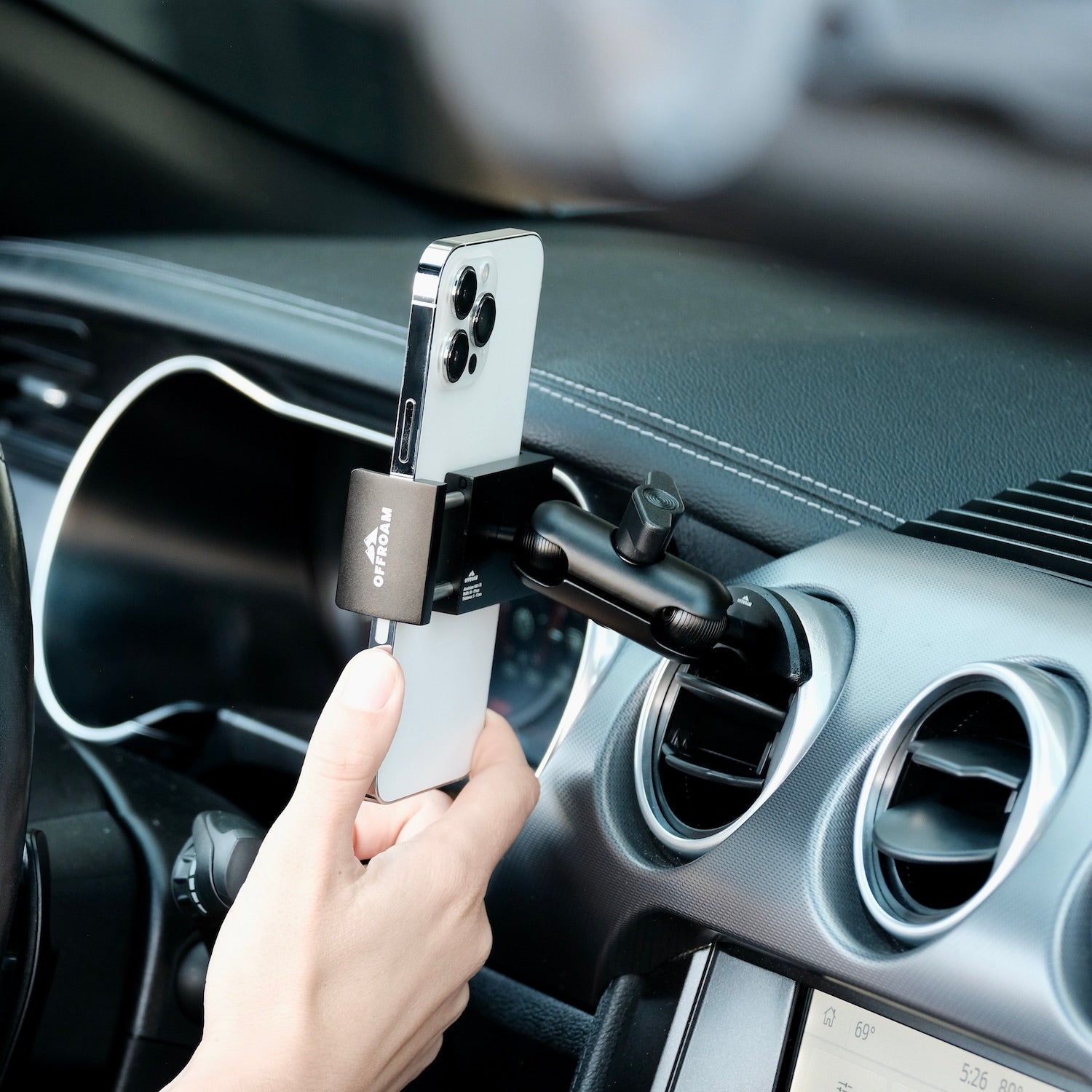 Image of Offroam Phone Mount installed securely in Ford Mustang 2015-2023. This premium phone mount installs easily without drilling or glue. Spring loaded Universal holder for use with any phone. Perfect placement without blocking screens, driver view, or air flow. Fully adjustable positioning.